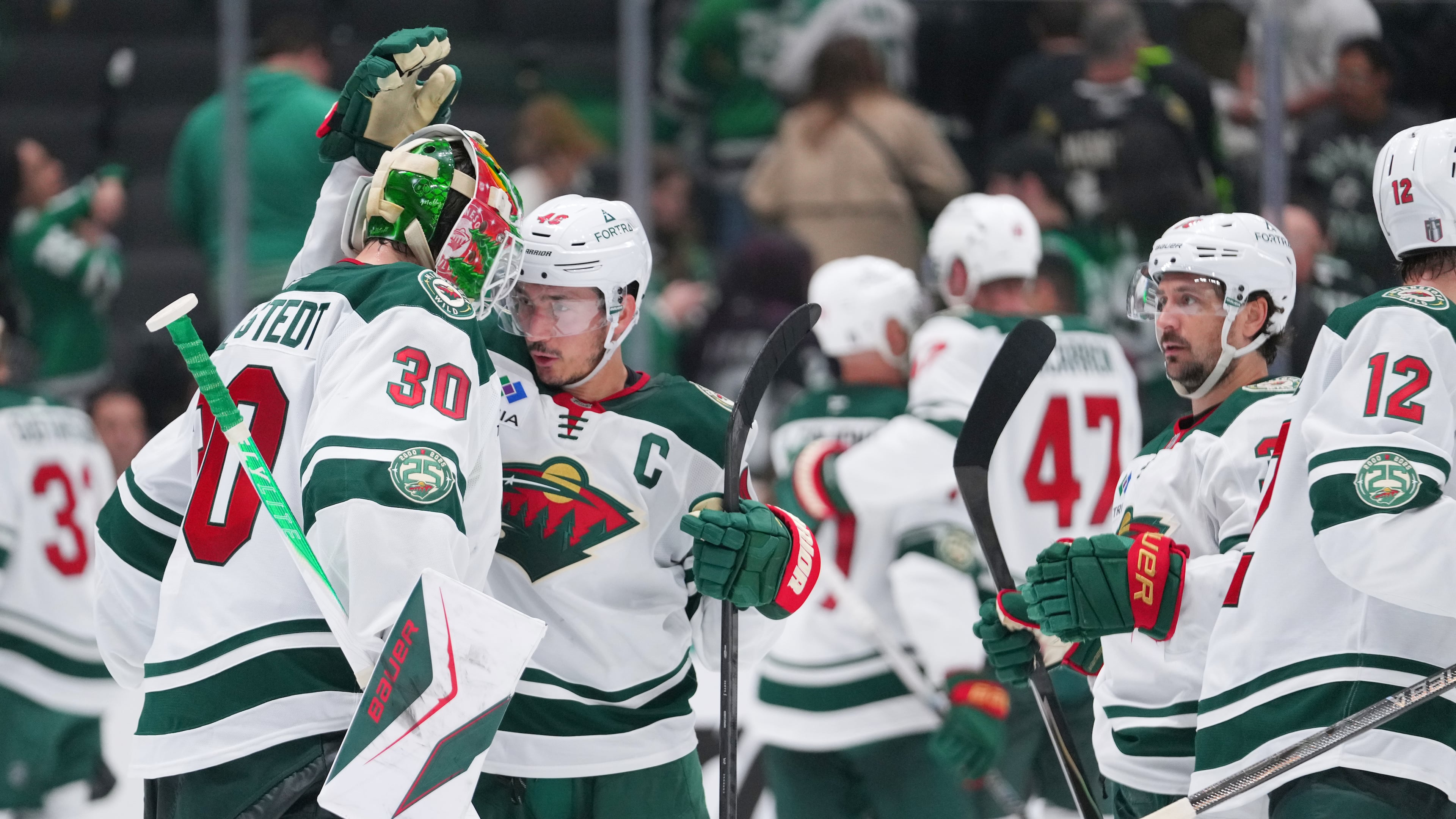 Minnesota Wild goaltender Jesper Wallstedt (30) reacts with defenseman Jared Spurgeon (46) after their team defeated the Dallas Stars 4-2 in Game 5 of a first-round NHL Stanley Cup playoffs hockey series, Tuesday, April 28, 2026, in Dallas. (AP Photo/Julio Cortez)