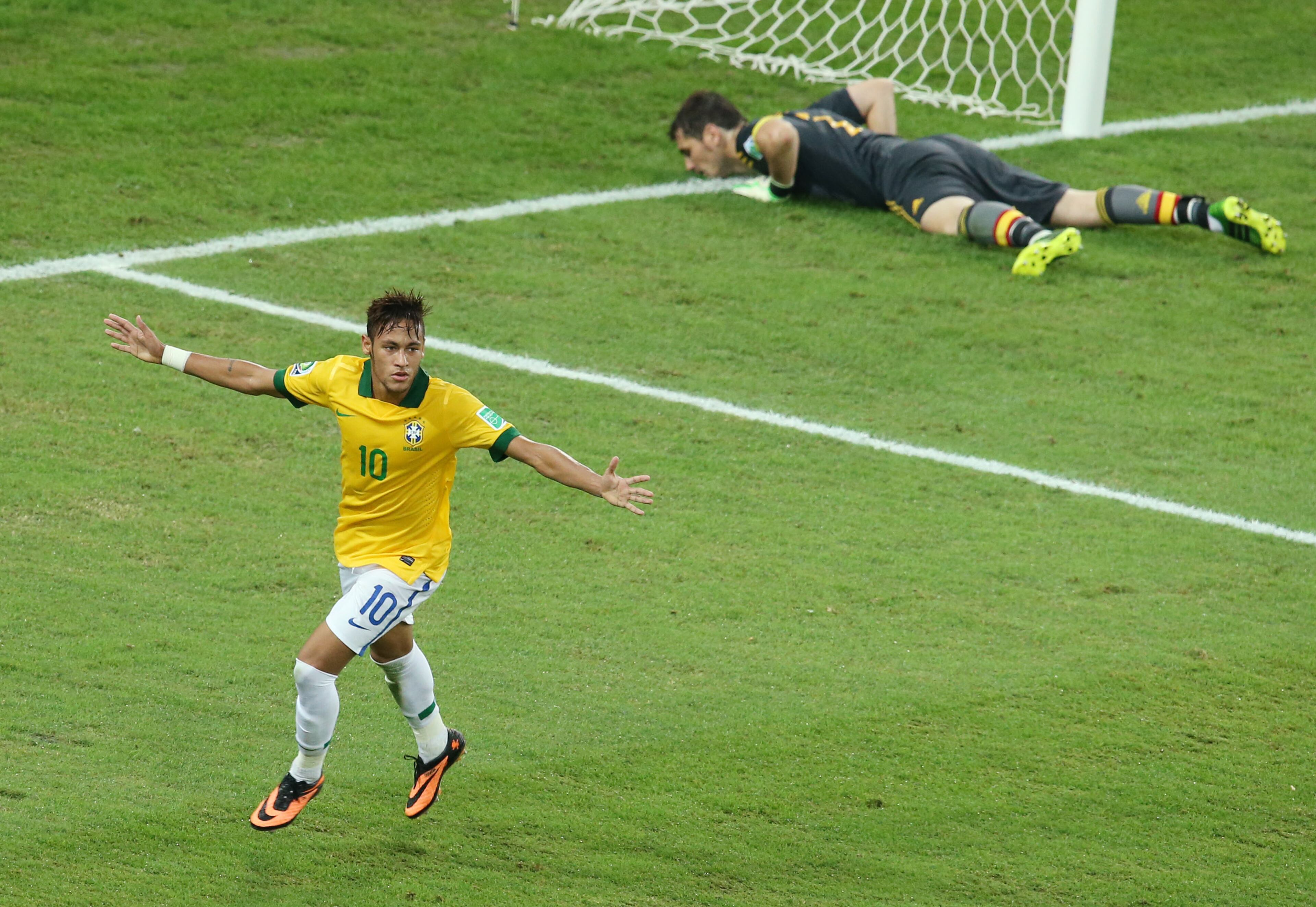 Brazil's Neymar celebrates scoring his side's 2nd goal as Spain's Iker Casillas, background, lies on the ground during the soccer Confederations Cup final between Brazil and Spain at the Maracana stadium in Rio de Janeiro, Brazil, Sunday, June 30, 2013. (AP Photo/Eugene Hoshiko)