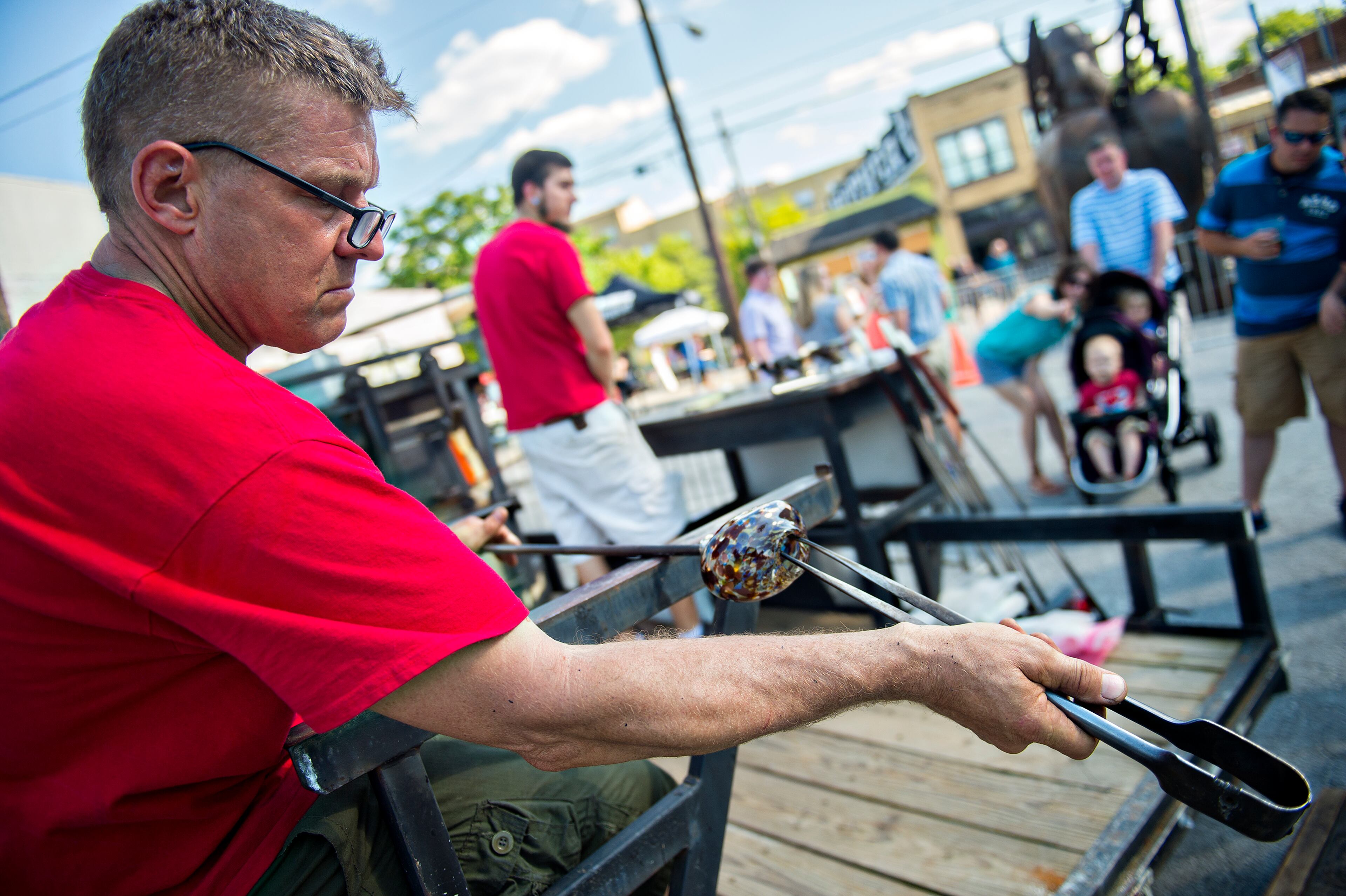 Matthew Janke blows glass during the Fire in the Fourth Festival in the Old Fourth Ward neighborhood of Atlanta on Saturday, May 2, 2015. The first annual festival featured a live musical and fire performances, firefighter muster relays, and aerial acrobatics by the Imperial Opa Circus. JONATHAN PHILLIPS / SPECIAL