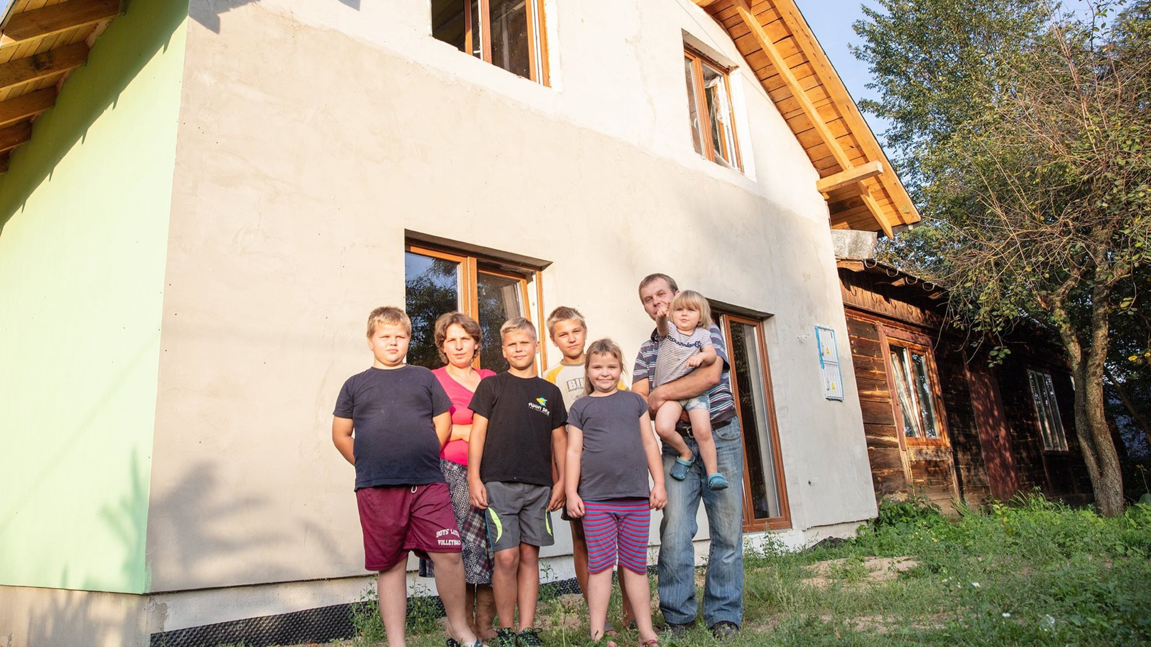 Over the past two years, Habitat for Humanity volunteers from seven different countries have helped build this two-story house for the Kawka family. The Kawkas currently live in a small, one-room house in the Polish village of Redzynskie. Shown here (from left to right) are Dominik, 9; his mother, Agata; his brothers, Kacper, 11, and Sebastian, 14; his sister Veronika, 8; and his father, Miroslaw, who is holding 3-year-old Amelka. The couple’s oldest son, Szymon, 16, is not pictured. During an informal dedication ceremony in July, Miroslaw Kawka thanked all the volunteers. “My family,” he said, “needed your help, and you gave.” CONTRIBUTED BY ANNALISE KAYLOR / HABITAT FOR HUMANITY INTERNATIONAL