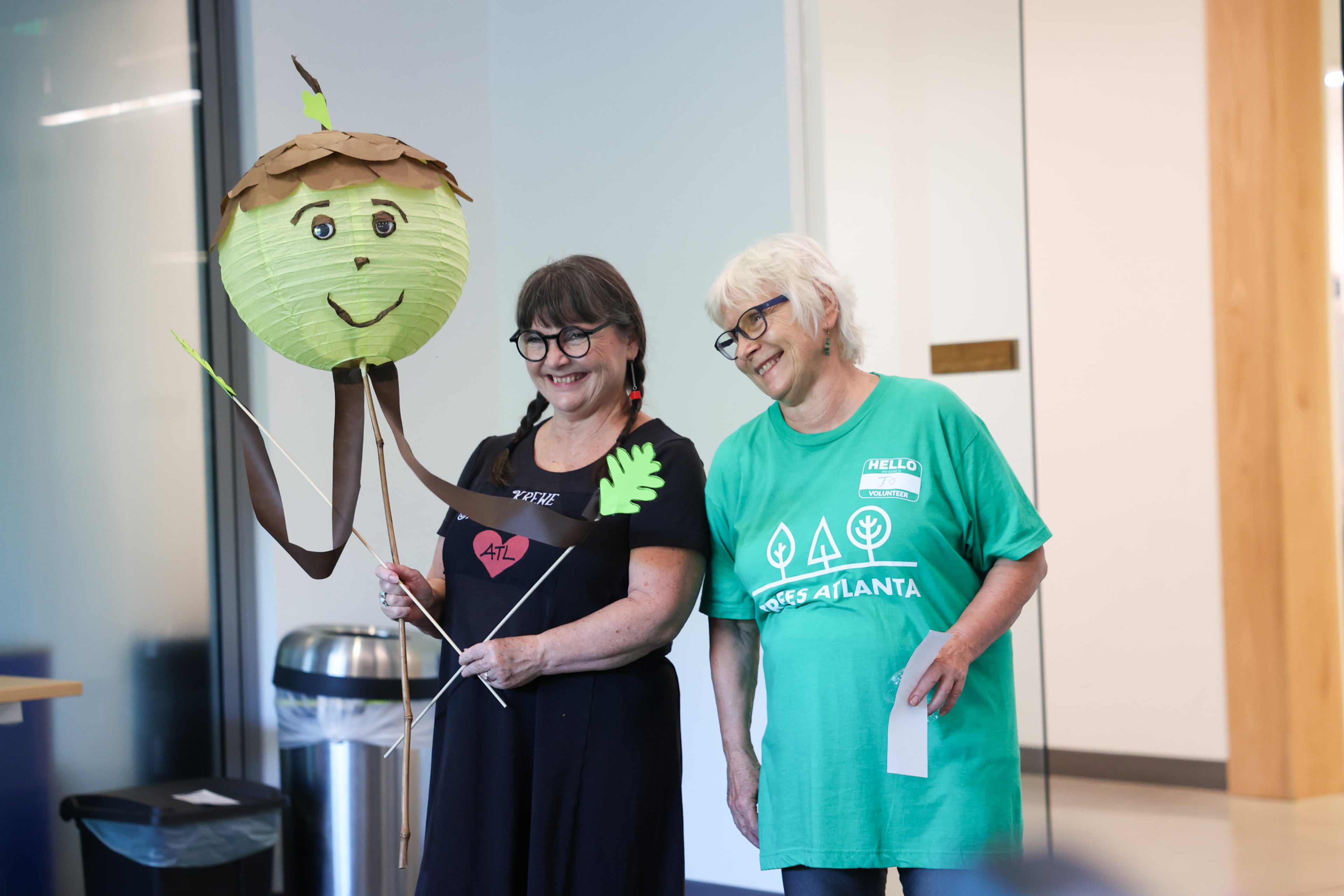 Atlanta Beltline Lantern Parade organizer Chantelle Rytter (left) and her mother, Jo, speak to volunteers at Trees Atlanta on Thursday, Sept. 10, 2026. The volunteer-made acorn lanterns will march alongside the Oak King lantern in Saturday's parade. (Arvin Temkar/AJC)