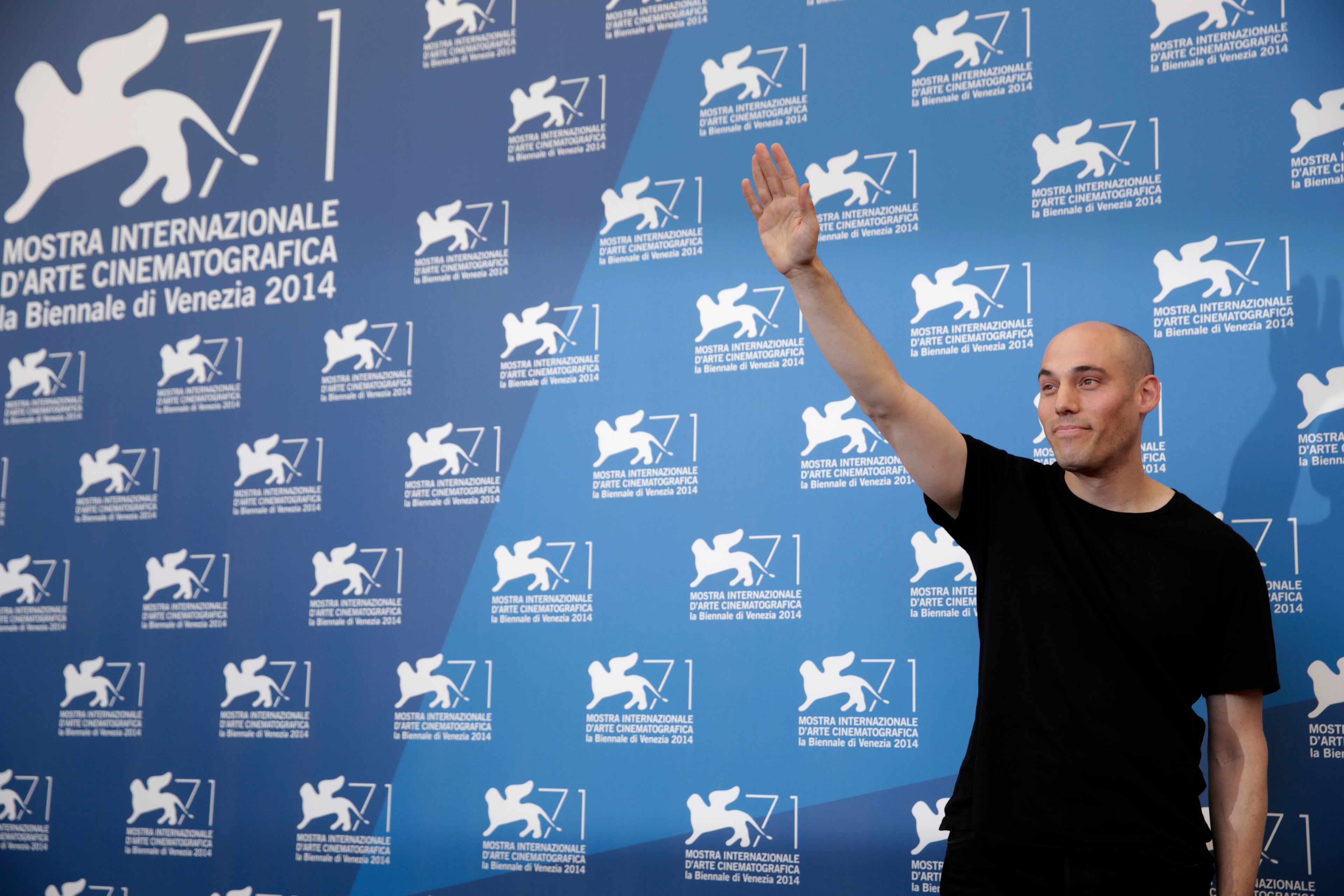 Director Joshua Oppenheimer poses for photographers at the photo call for the film The Look of Silence the 71st edition of the Venice Film Festival in Venice, Italy, Thursday, Aug. 28, 2014. (AP Photo/David Azia)