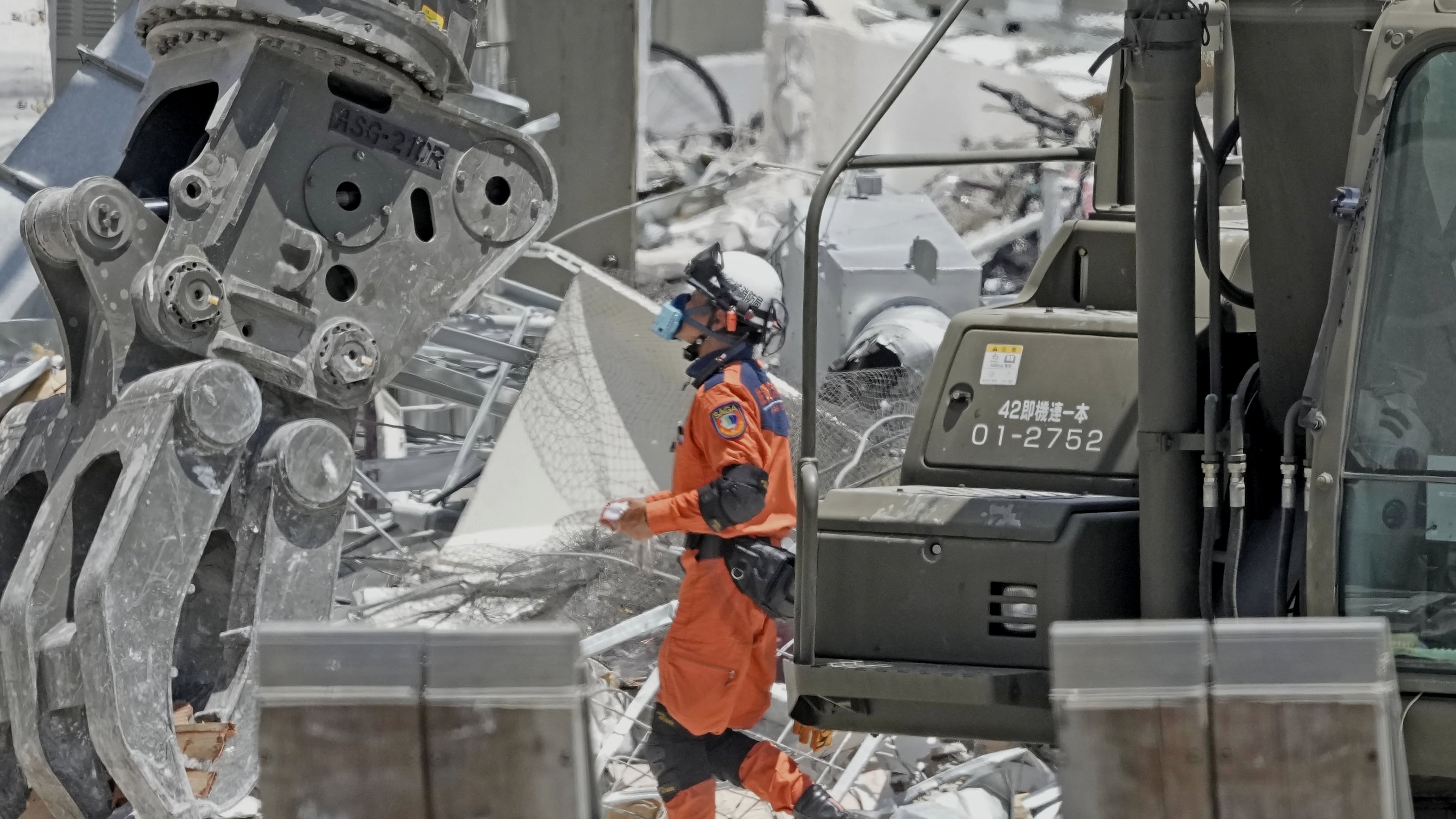 A firefighter searches the damaged AEON Mall following an explosion triggered by an earthquake in Kashima, Kumamoto Prefecture, southern Japan, Friday, July 31, 2026. (Kai Naito/Kyodo News via AP)