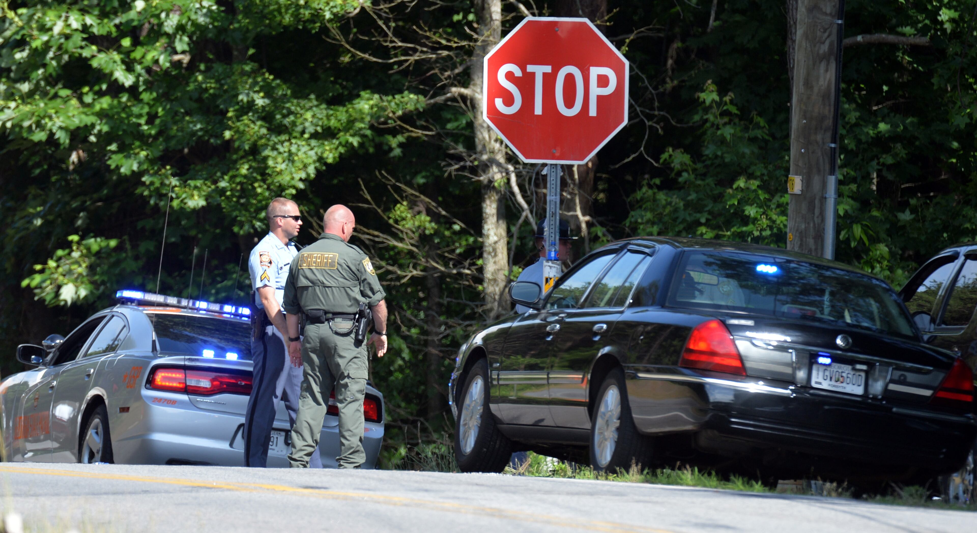 Law enforcement blocks streets near the home of Dennis Marx, the suspect in the Forsyth County Courthouse shooting, in Cumming on Friday, June 6, 2014.