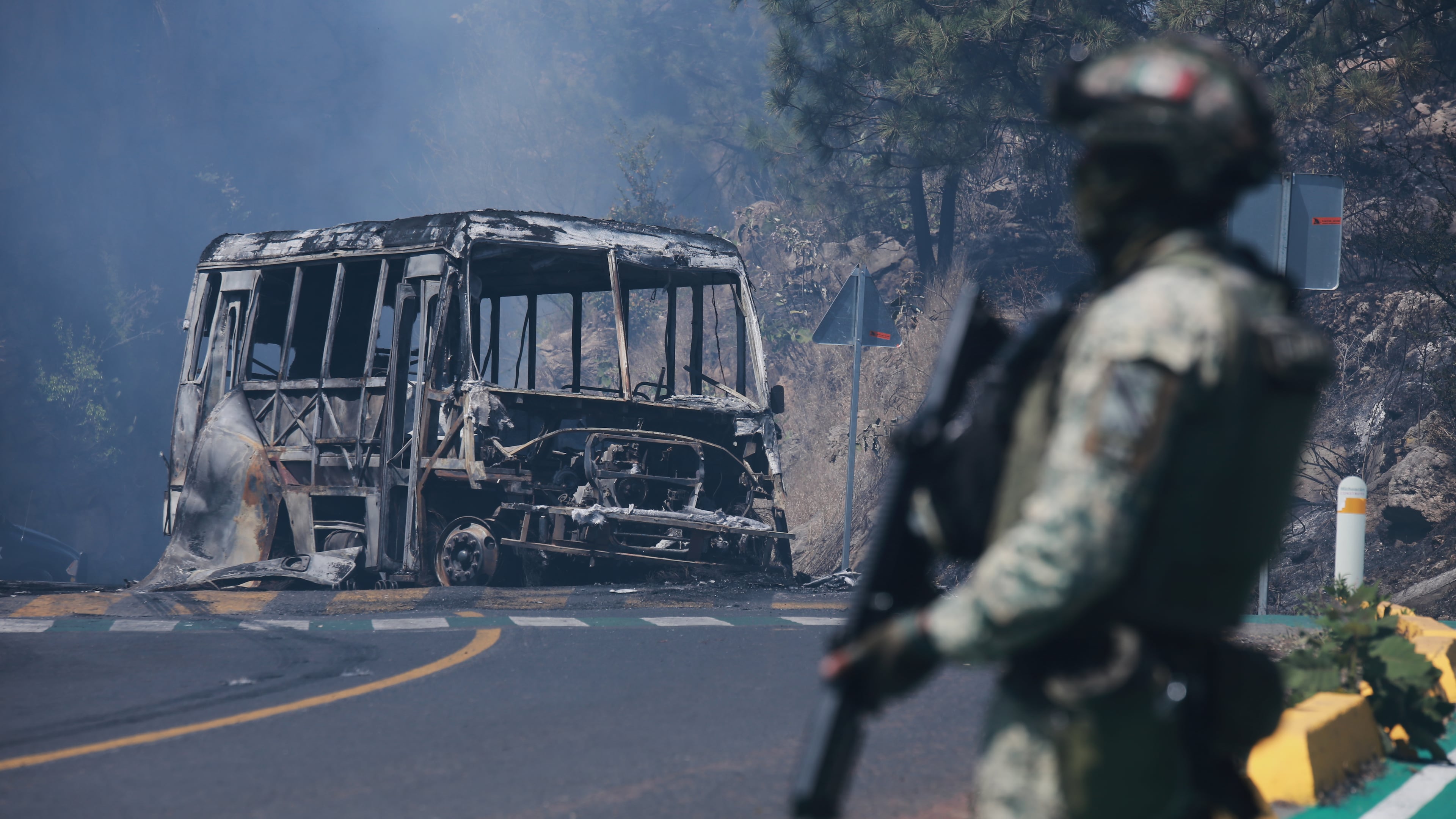 FILE - A soldier stands guard by a charred vehicle after it was set on fire in Cointzio, Michoacán state, Mexico, Feb. 22, 2026, following the death of the leader of the Jalisco New Generation Cartel, Nemesio Oseguera, also known as "El Mencho." (AP Photo/Armando Solis, File)