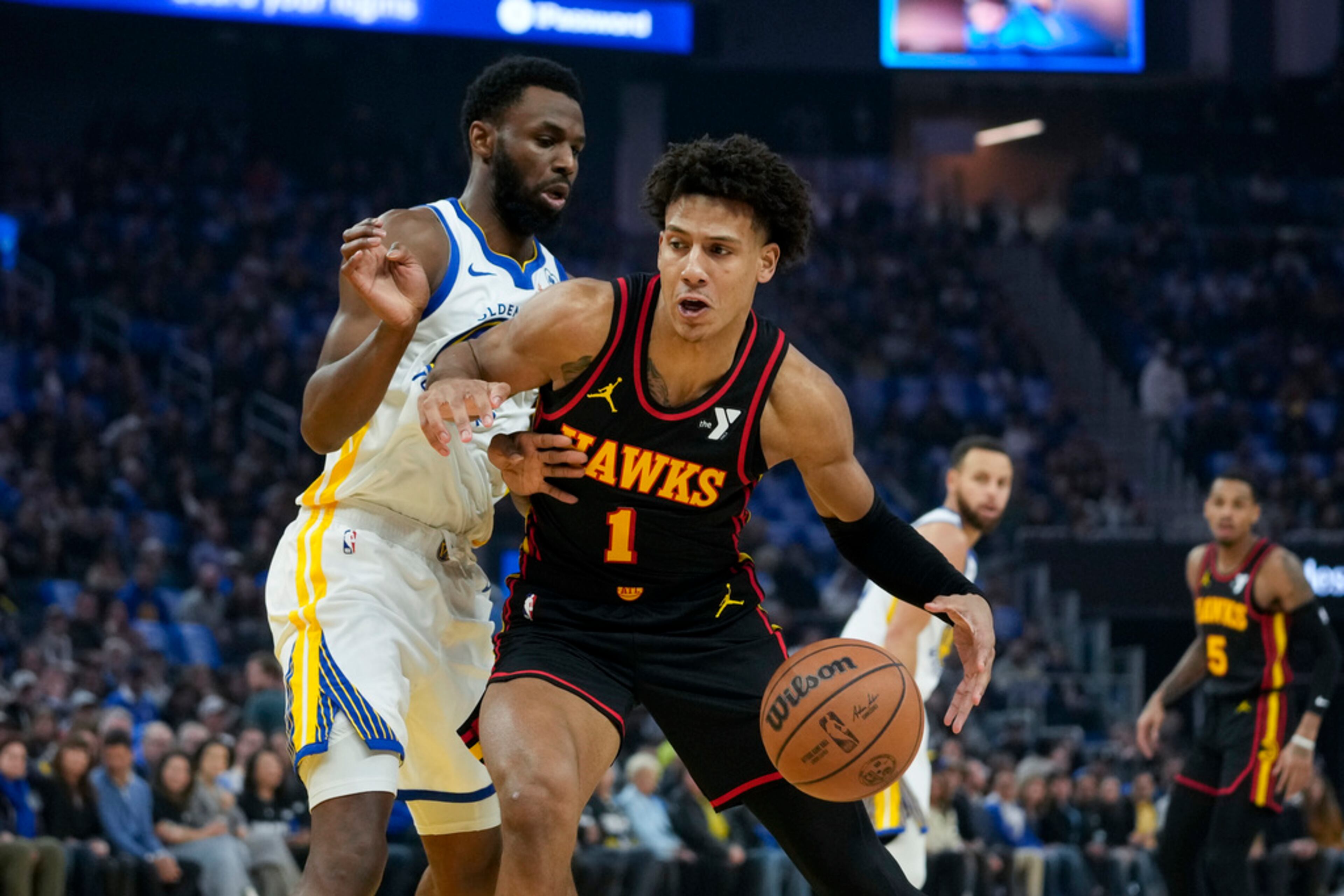 Atlanta Hawks forward Jalen Johnson (1) tries to get around Golden State Warriors forward Andrew Wiggins during the first half of an NBA basketball game, Wednesday, Jan. 24, 2024, in San Francisco. (AP Photo/Godofredo A. Vásquez)