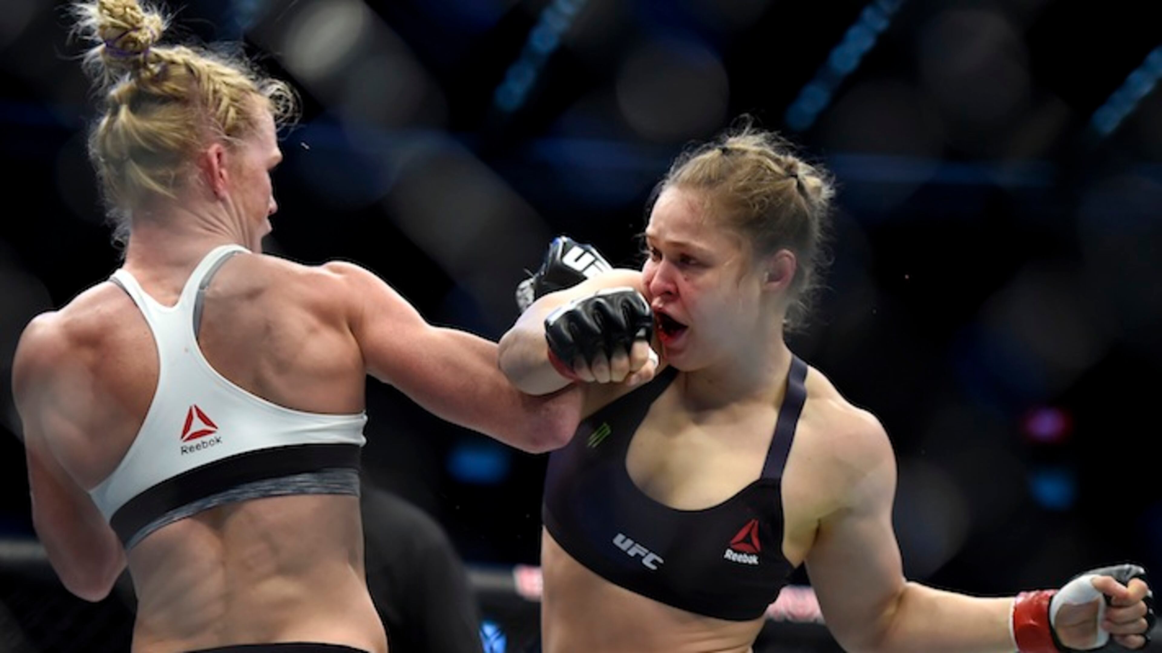 Holly Holm, left punches Ronda Rousey during thier UFC 193 Bantamweight title fight in Melbourne, Australia, Sunday, Nov. 15, 2015. (AP Andy Brownbill)