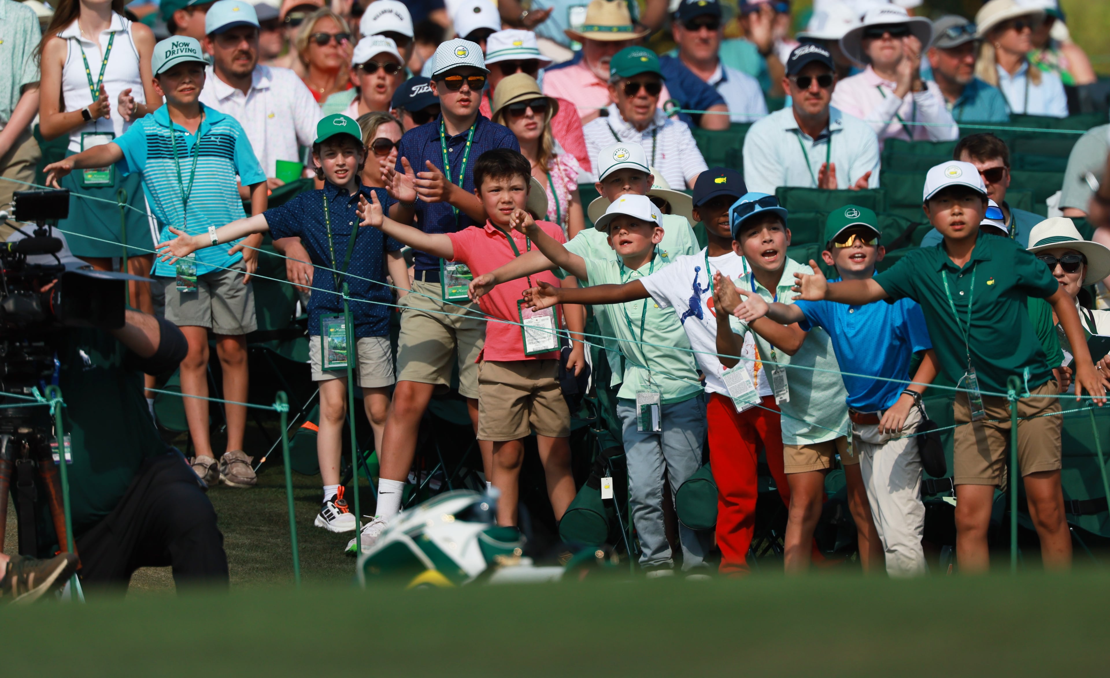 Young golf fans try to greet Tyrrell Hatton as he comes off the 18th green during final round of the Masters, at Augusta National Golf Club, Sunday, April 12, 2026, in Augusta, GA (Jason Getz/AJC)