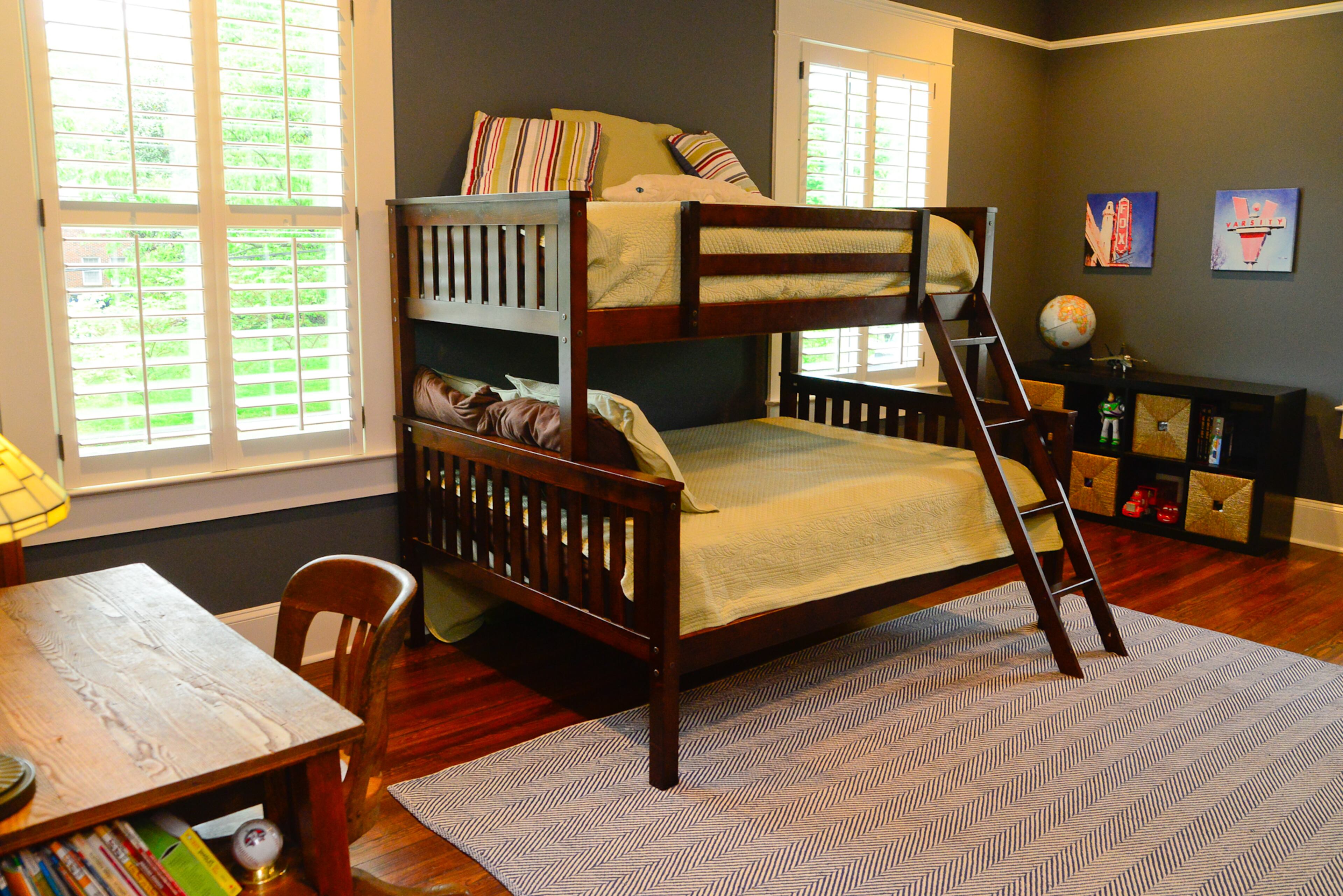 Functionality was key in the kids' rooms, with storage, an antique desk and bunk beds. The artwork, on walls painted Sherwin-Williams' Gibraltar, gives a nod to Atlanta landmarks - The Varsity and the Fox Theatre.