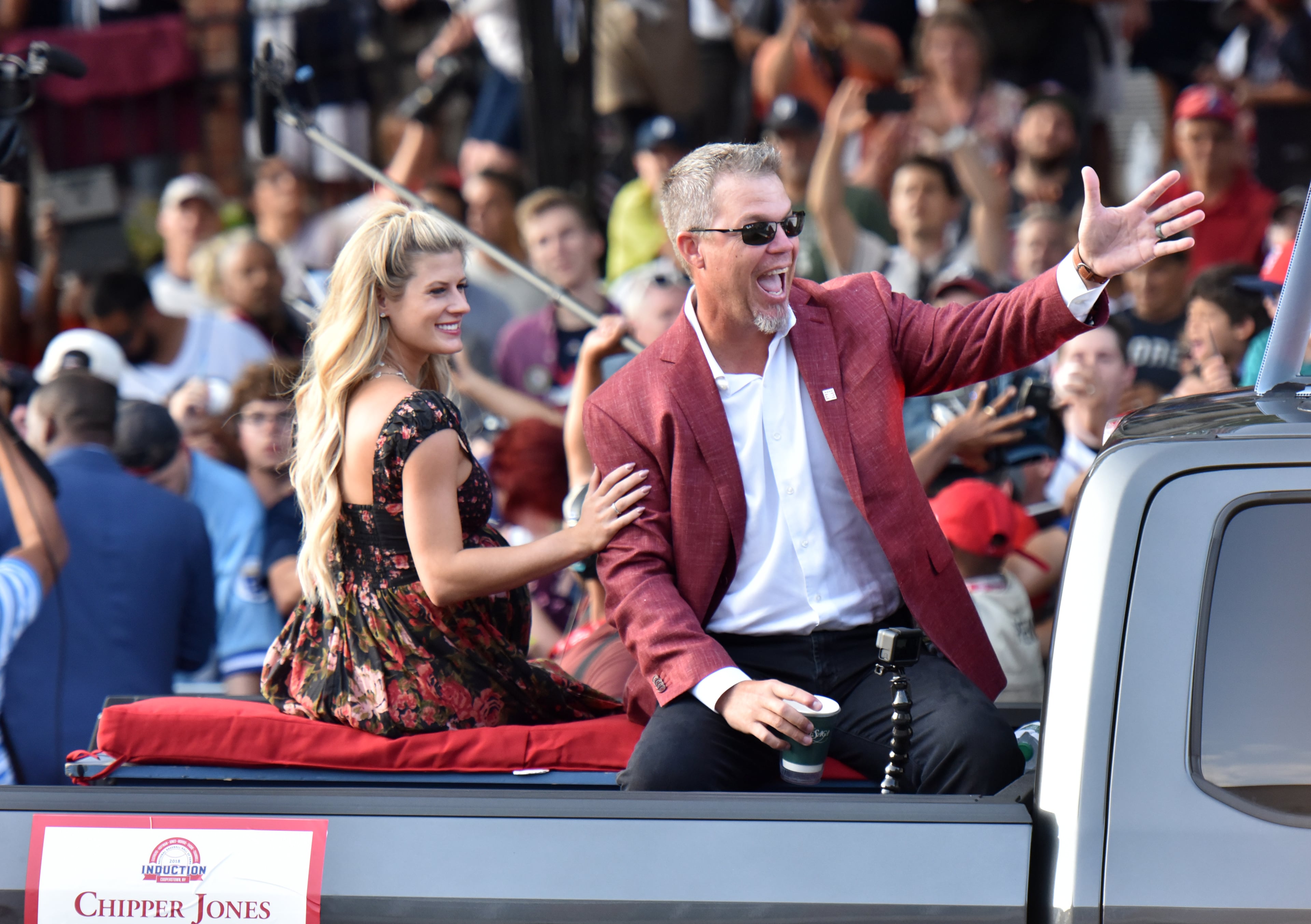 July 28, 2018 Cooperstown, N.Y. - Braves legend Chipper Jones and his wife Taylor wave to fans from the back of a pickup truck during Hall of Fame Legends Parade in Cooperstown, N.Y. on Saturday, July 28, 2018. Braves legend Chipper Jones is set for induction into the National Baseball Hall of Fame on Sunday in Cooperstown, N.Y. HYOSUB SHIN / HSHIN@AJC.COM