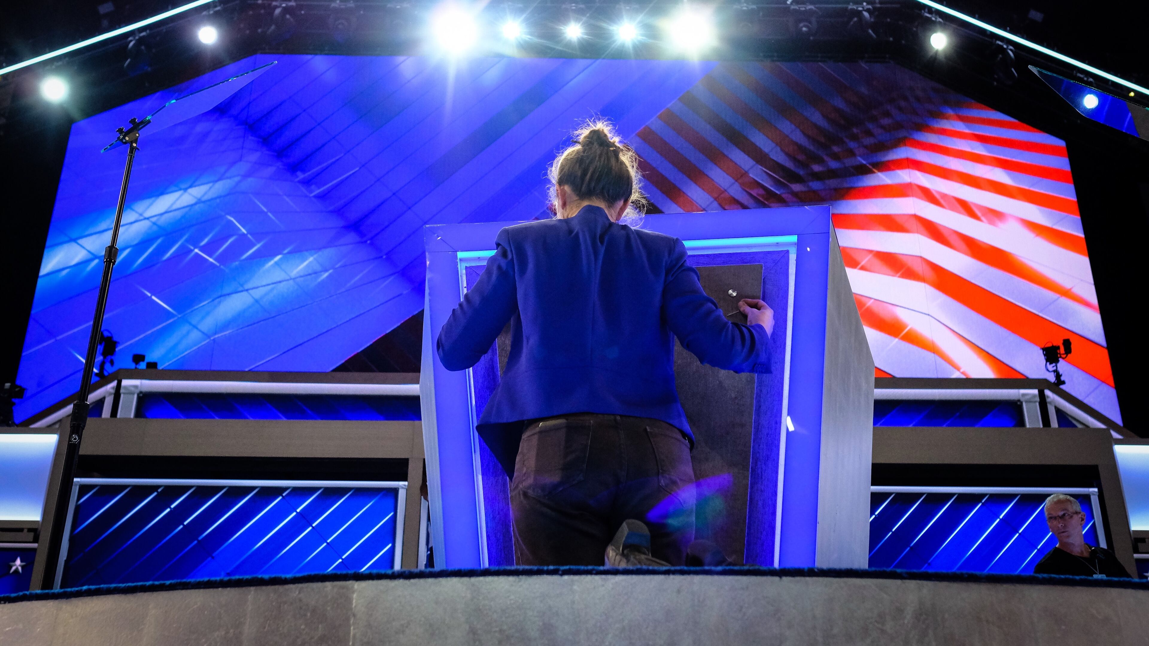 Final touches are made to the podium Sunday evening, July 24, 2016, as the Democratic National Convention prepares to kickoff on Monday in Philidelphia. (AP Photo/J. David Ake)