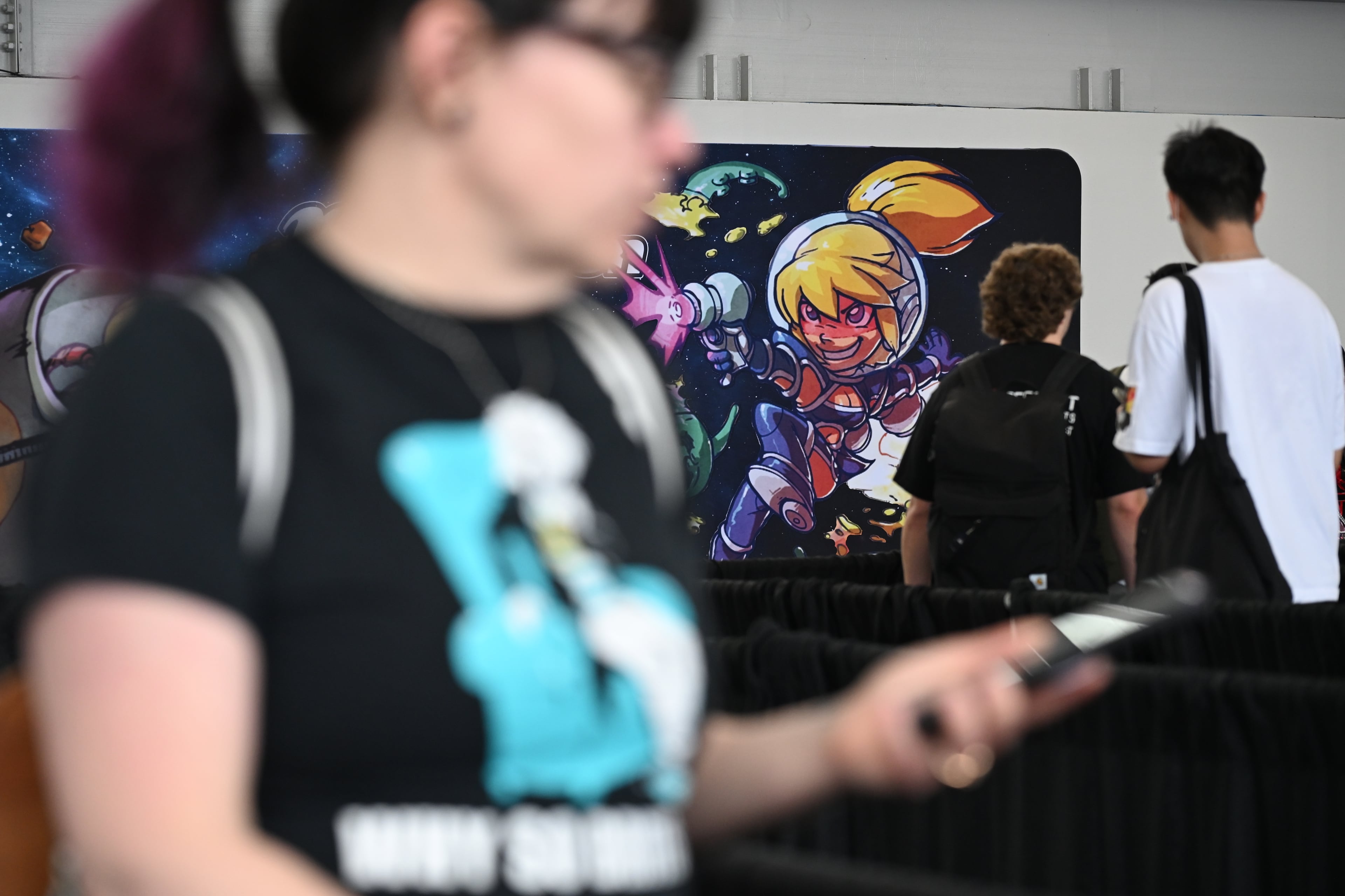 Attendees wait to enter MomoCon at the Georgia World Congress Center in Atlanta on Friday, May 22, 2026. (Tyler Sun for the AJC)