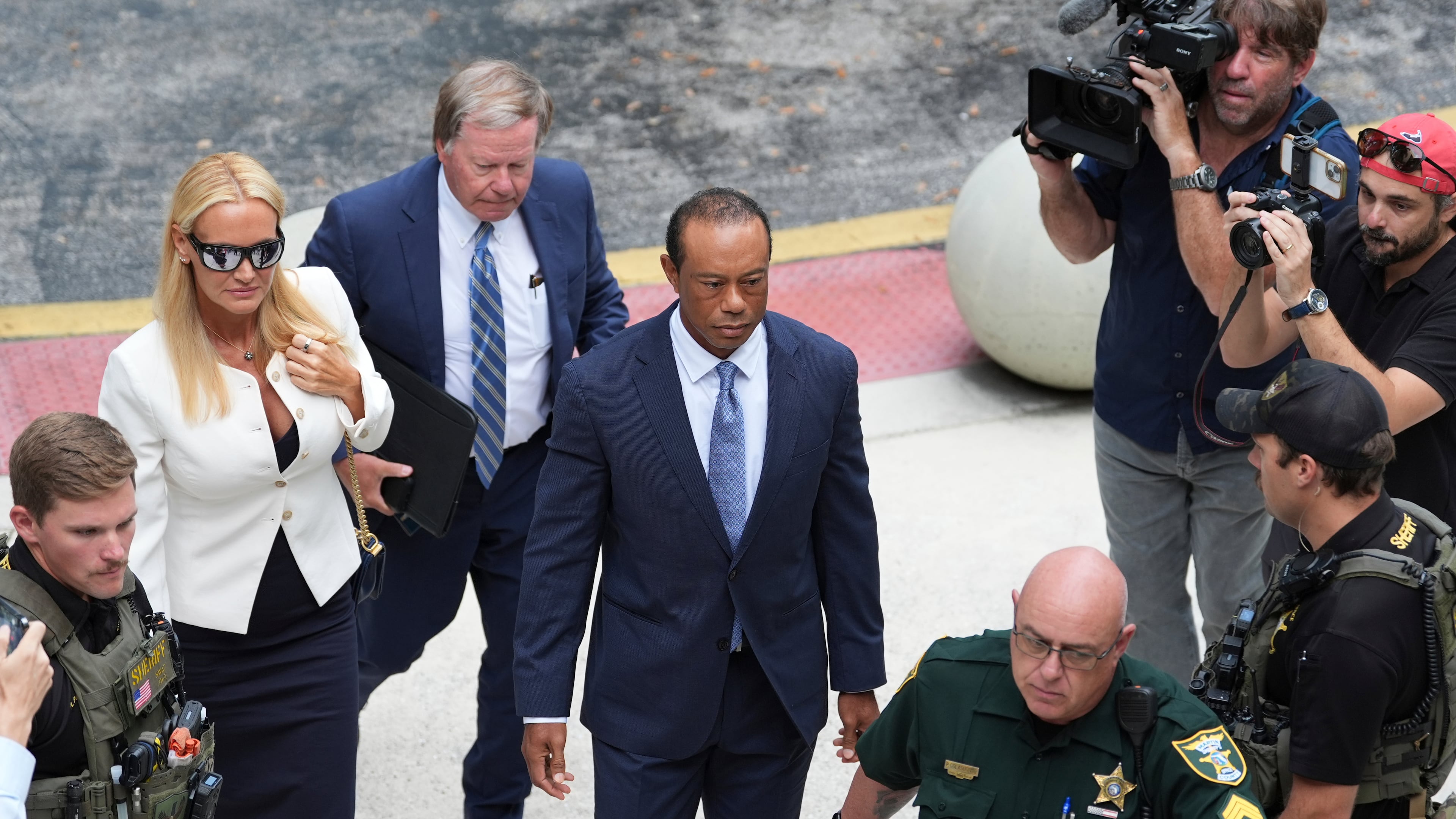 Golfer Tiger Woods, right, arrives with Vanessa Trump, left, for Woods' plea conference hearing in a DUI case stemming from a rollover crash in Florida in March, Wednesday, Sept. 2, 2026, in Stuart, Fla. (AP Photo/Rebecca Blackwell)