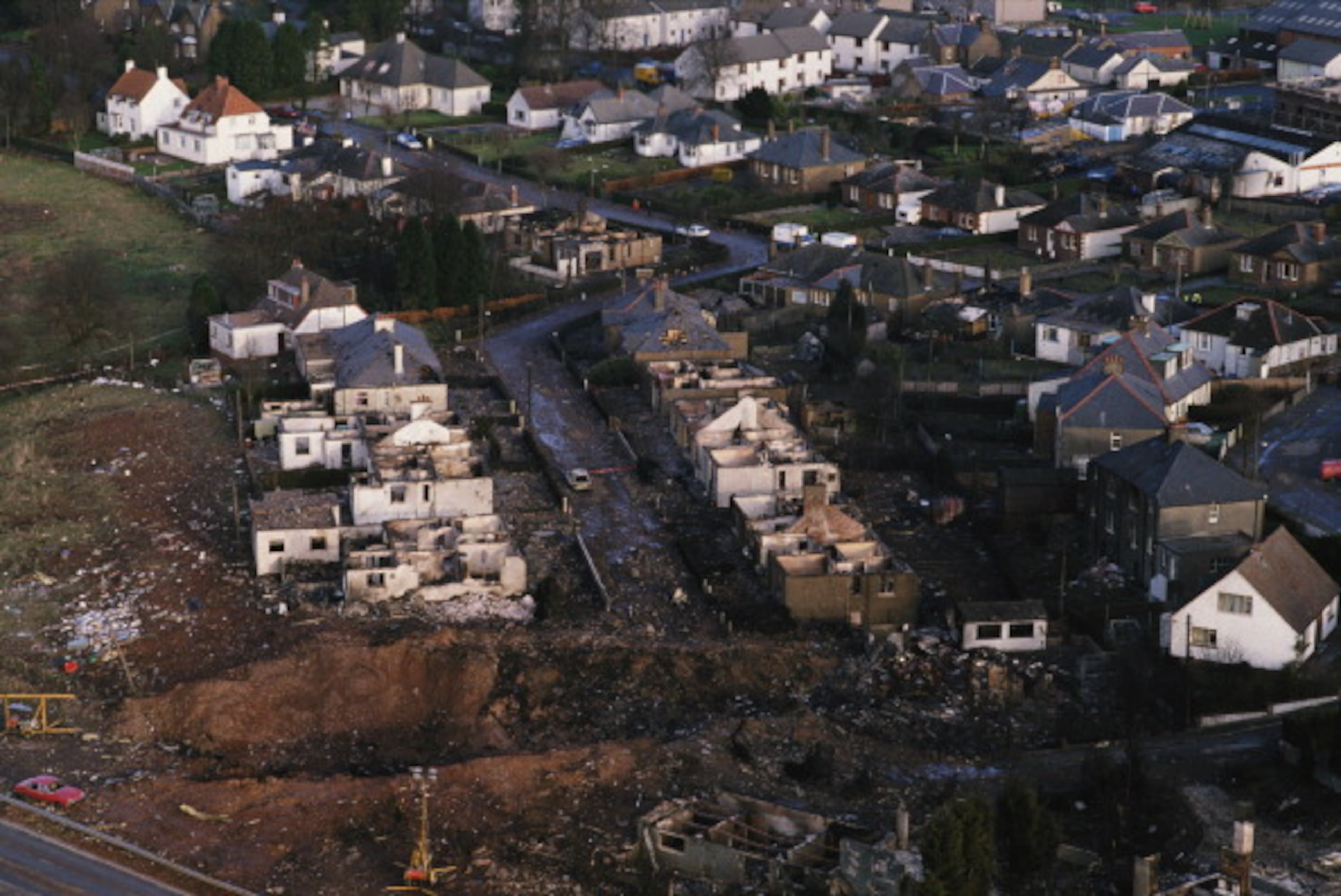 December 1988: Some of the destruction caused by Pan Am Flight 103 after it crashed onto the town of Lockerbie in Scotland, on 21st December 1988. The Boeing 747 'Clipper Maid of the Seas' was destroyed en route from Heathrow to JFK Airport in New York, when a bomb was detonated in its forward cargo hold. All 259 people on board were killed, as well as 11 people in the town of Lockerbie. (Photo by Bryn Colton/Getty Images)