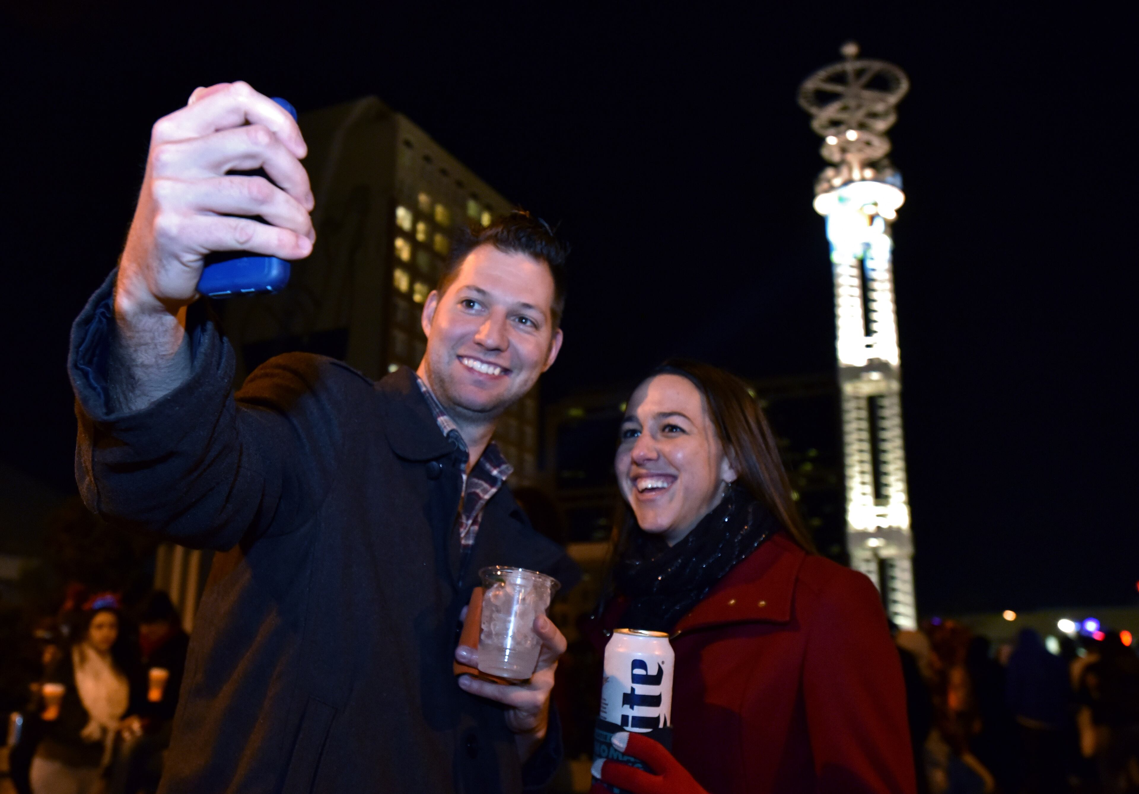 Katie and Will Thomas, of Atlanta, take a selfie with the peach at Underground Atlanta during Peach Drop 2016 on Thursday, December 31, 2015. HYOSUB SHIN / HSHIN@AJC.COM