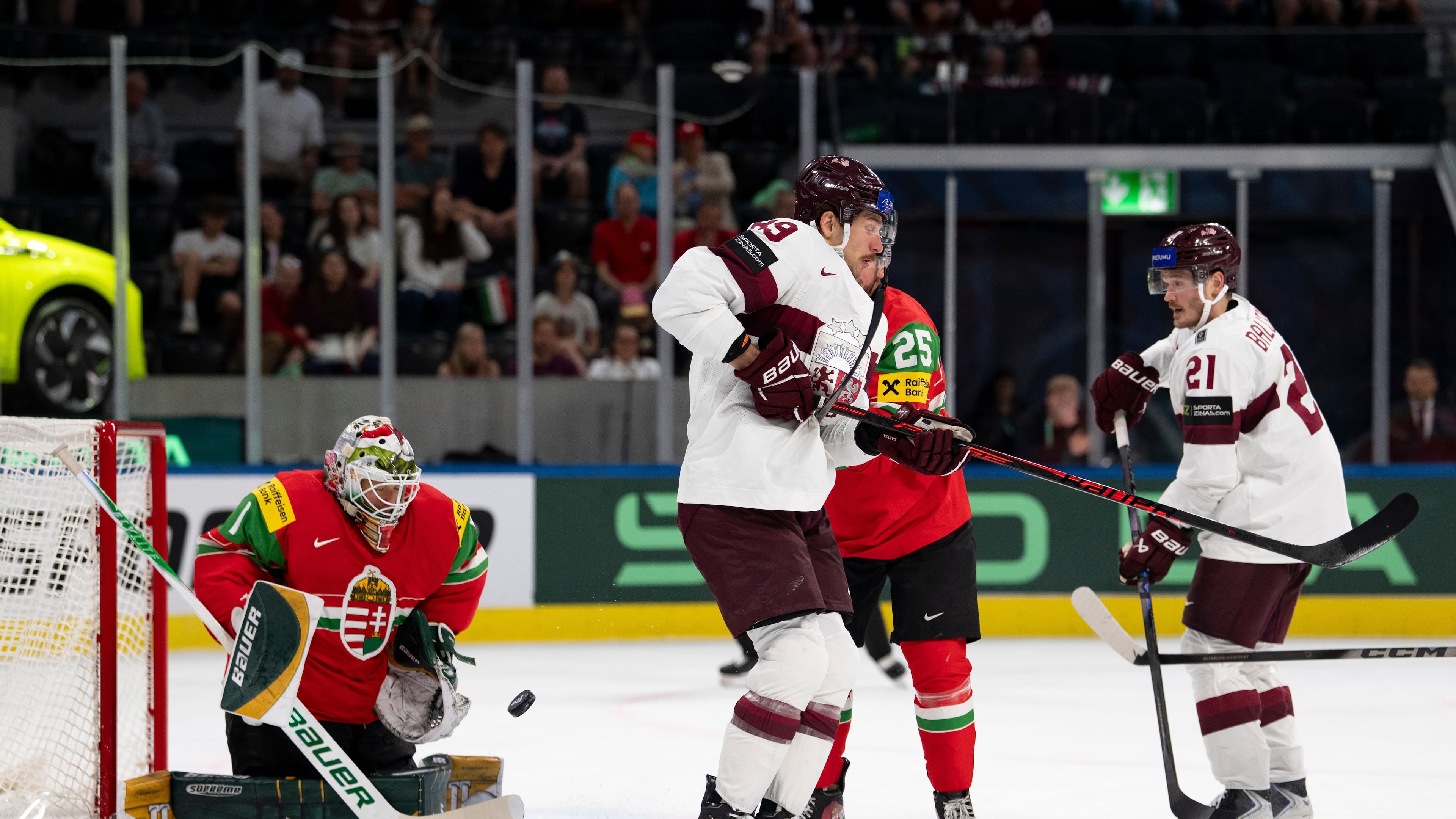 From left: Hungary's goaltender Bence Balizs, Latvia's Filips Buncis, Hungary's Gabor Tornyai and Latvia's Rudolfs Balcers fight for the puck during the 2026 IIHF Men's Ice Hockey World Championship preliminary round group A game between Hungary and Latvia, in Zurich, Switzerland, Tuesday, May 26, 2026. (Claudio Thoma/Keystone via AP)