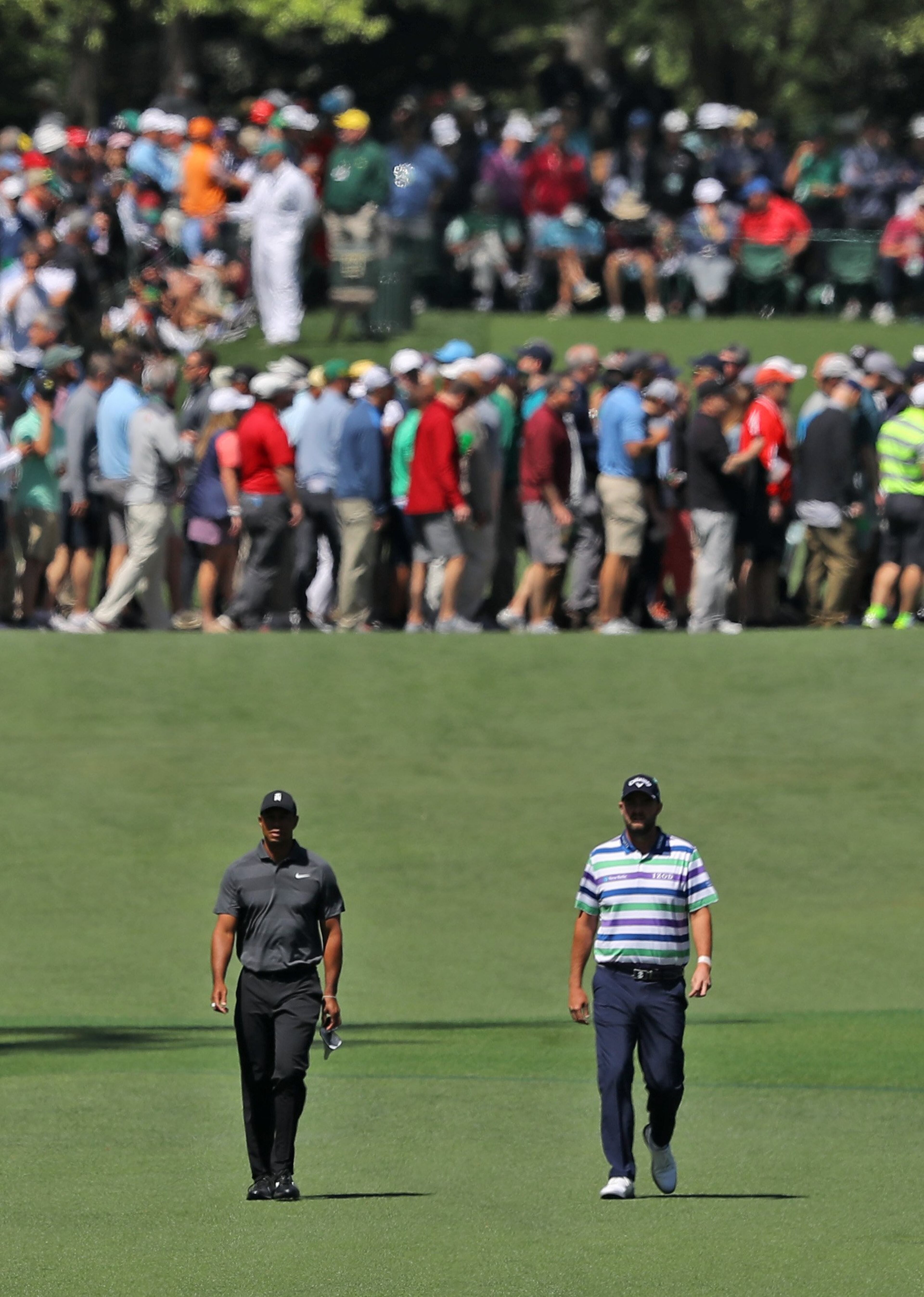 4/5/18 - Augusta - Marc Leishman (right) and Tiger Woods on the seventh fairway during the first round of the Masters at Augusta National Golf Club on Thursday, April 5, 2018, in Augusta. Curtis Compton/ccompton@ajc.com