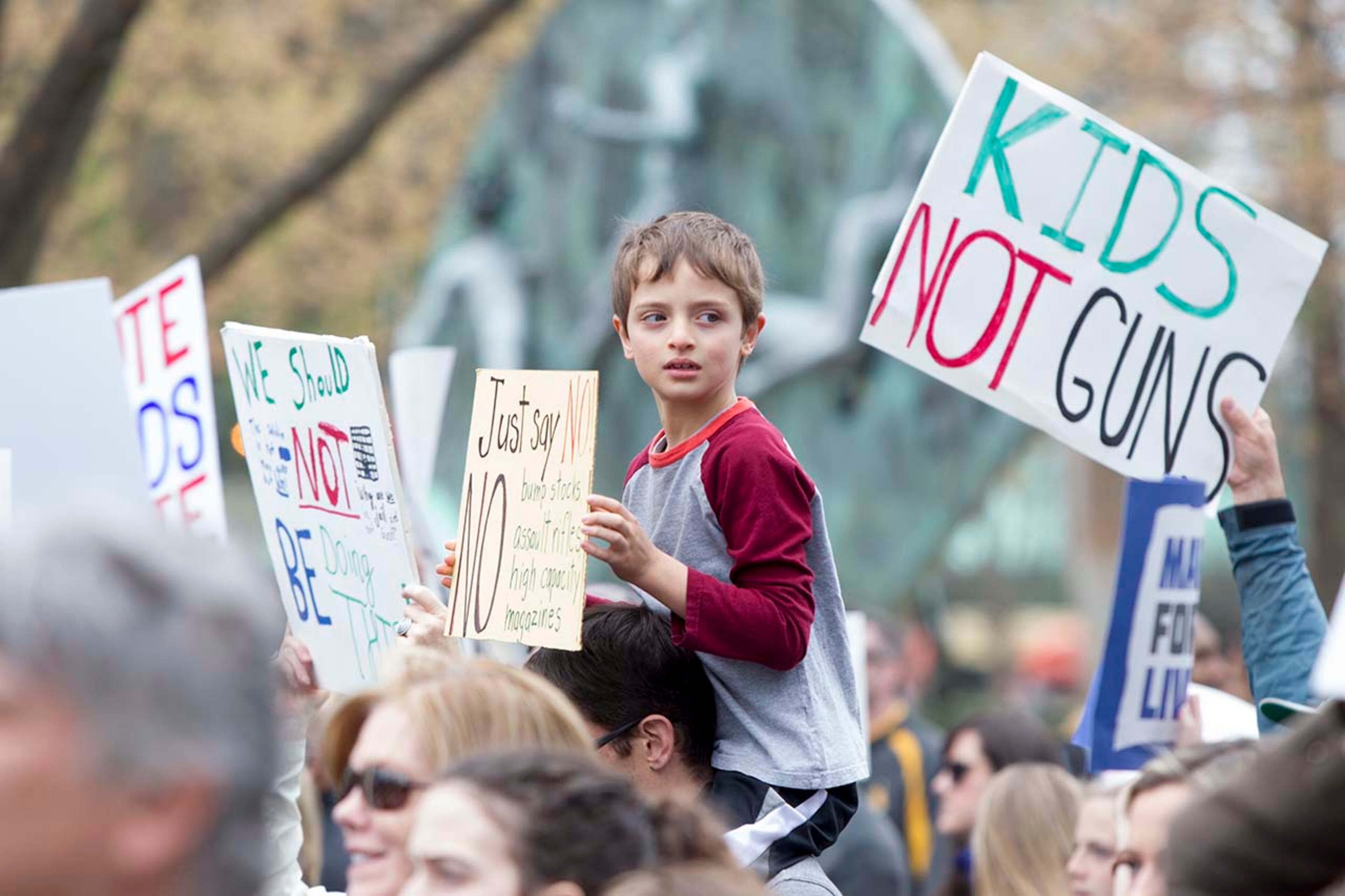 A boy holds up a sign during the March for our Lives event in Atlanta, Georgia, on Saturday, March 24, 2018. (REANN HUBER/REANN.HUBER@AJC.COM)