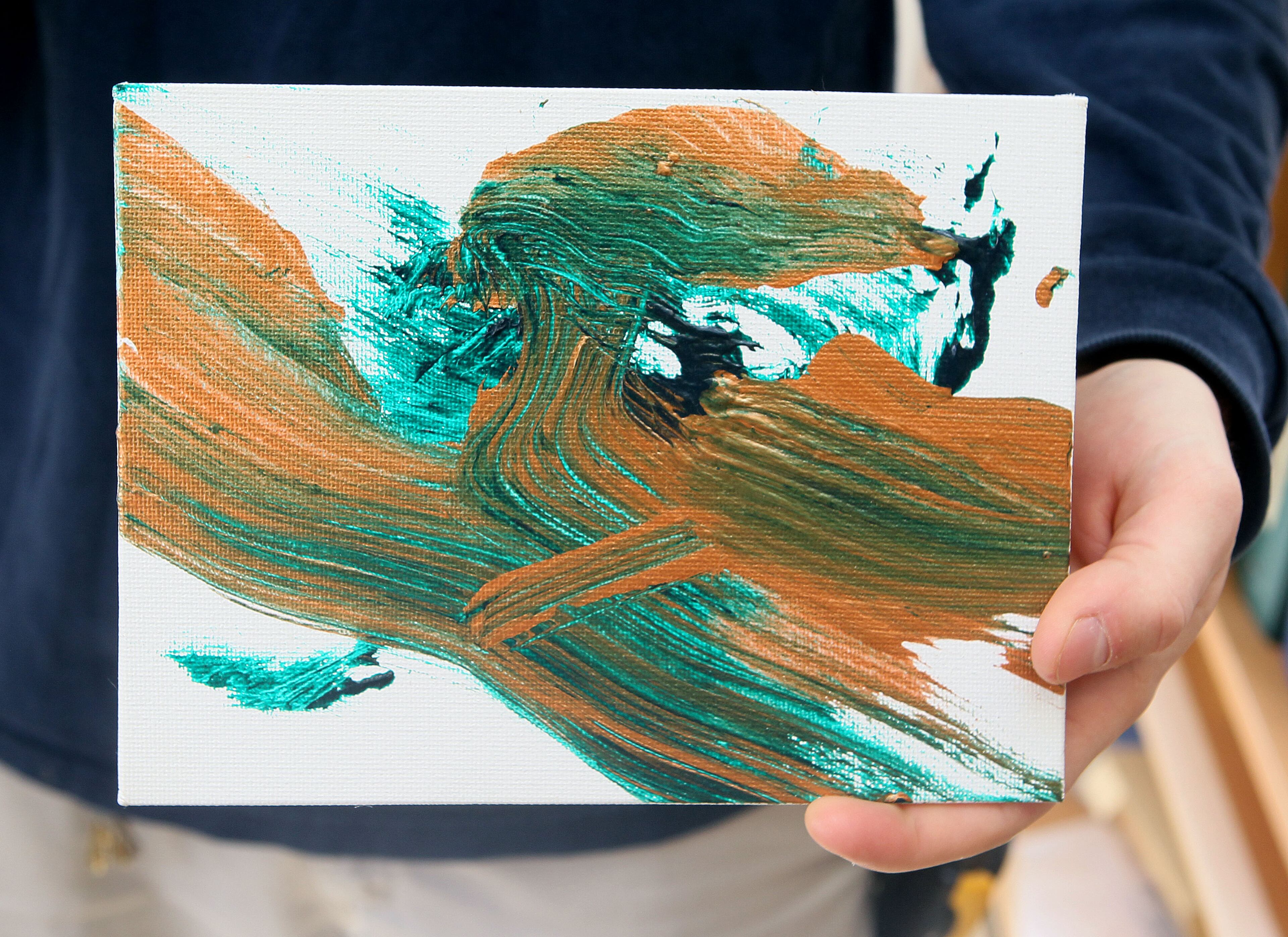 Zoo Atlanta's Bobby Fellows holds up artwork by one of the gorillas.