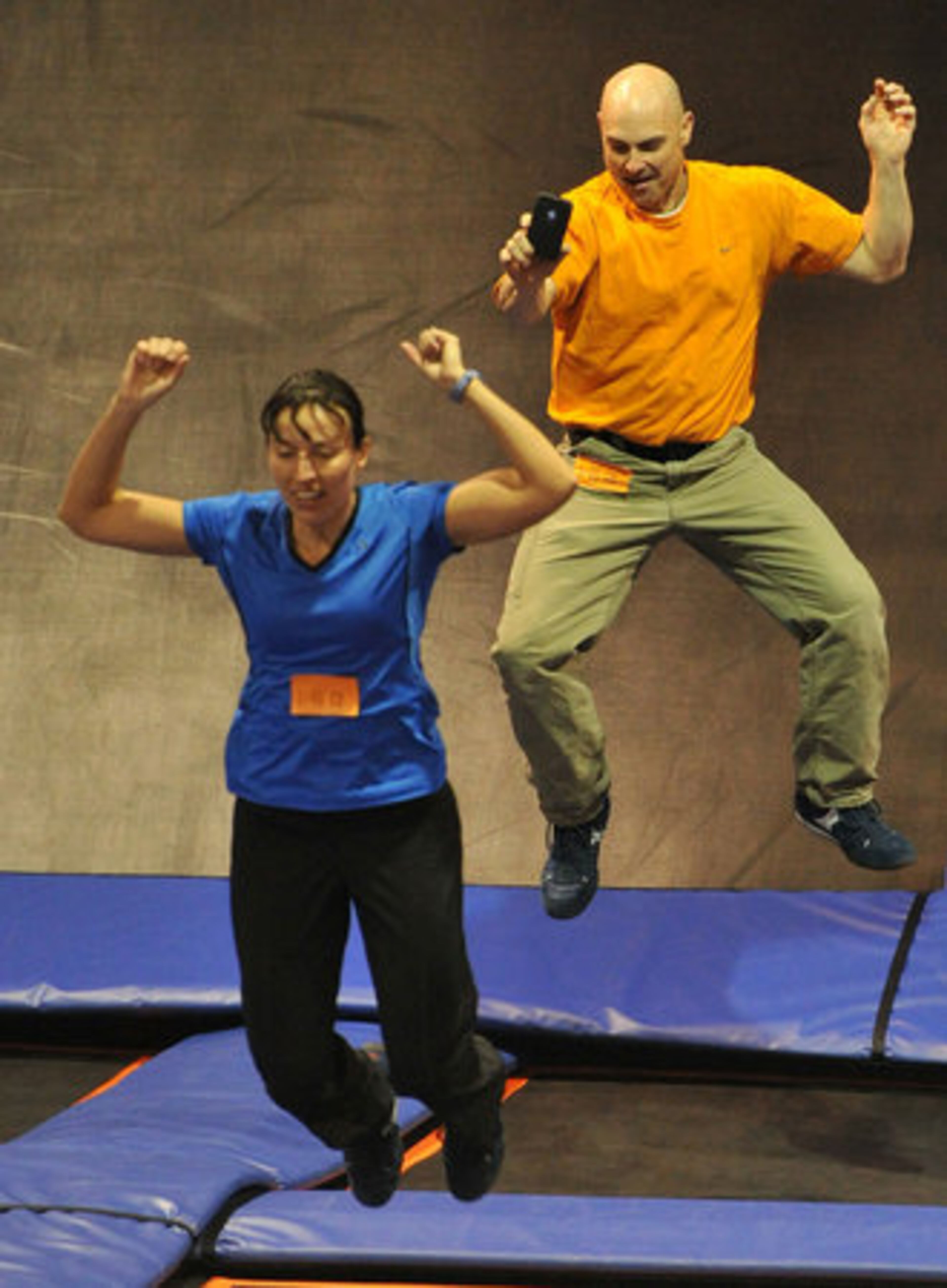 Charles Harker, Cumming, tries to take a photo of his wife, Cathy Harker, with his cell phone as he catches some air.