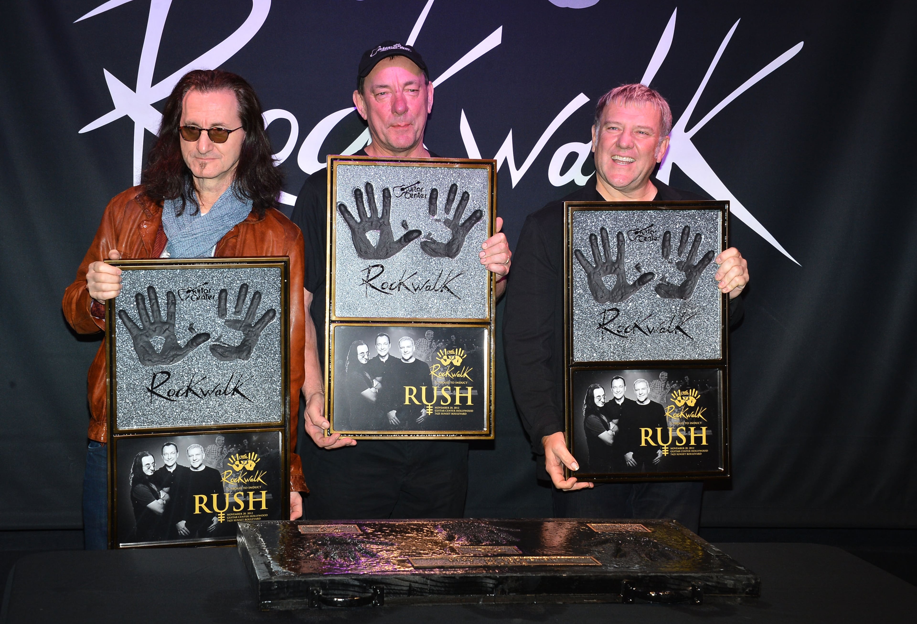 Rush (L-R ) Geddy Lee, Neil Peart, Alex Lifeson, Honored On Guitar Center's RockWalk at Guitar Center on November 20, 2012 in Hollywood, California. (Photo by Frazer Harrison/Getty Images)