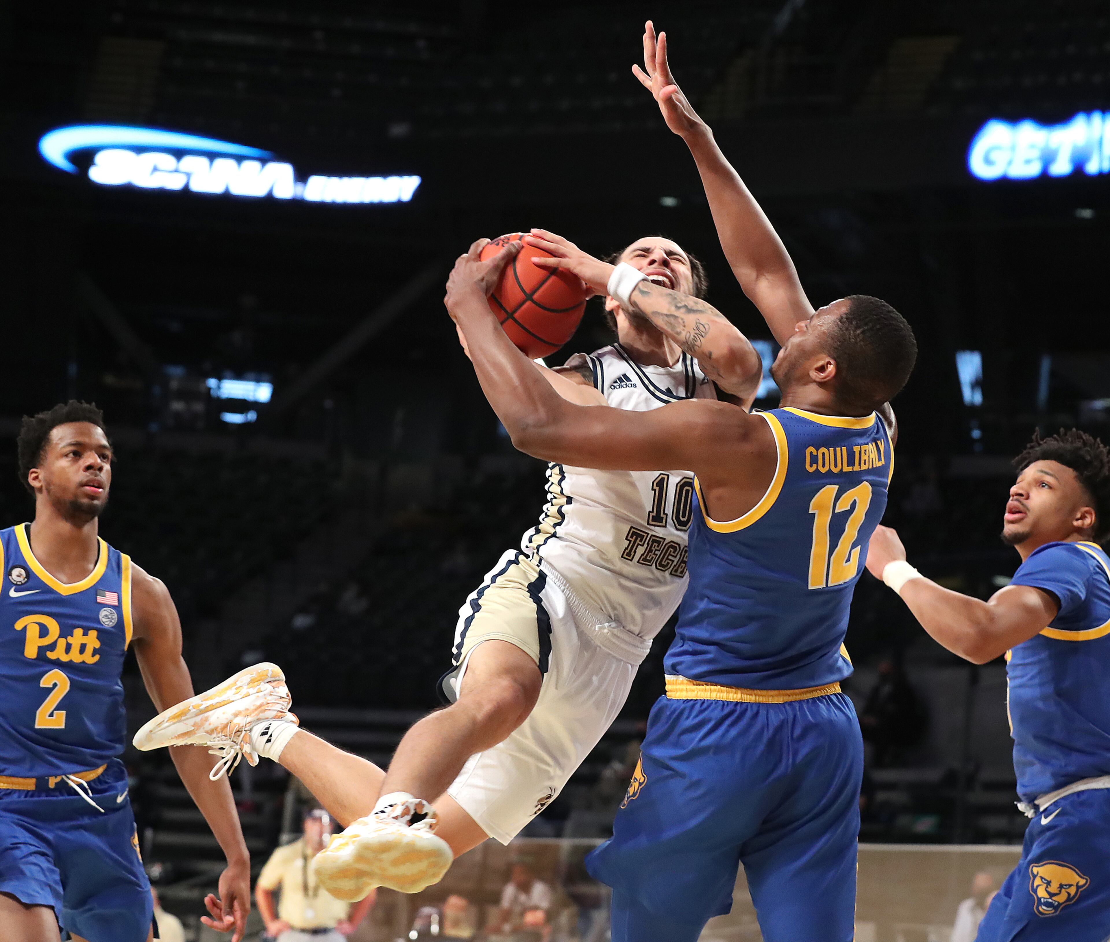 021421 Atlanta: Georgia Tech guard Jose Alvarado is fouled driving to the basket by Pittsburgh forward Abdoul Karim Coulibaly in an NCAA college basketball game on Sunday, Feb 14, 2021, in Atlanta. Curtis Compton / Curtis.Compton@ajc.com”