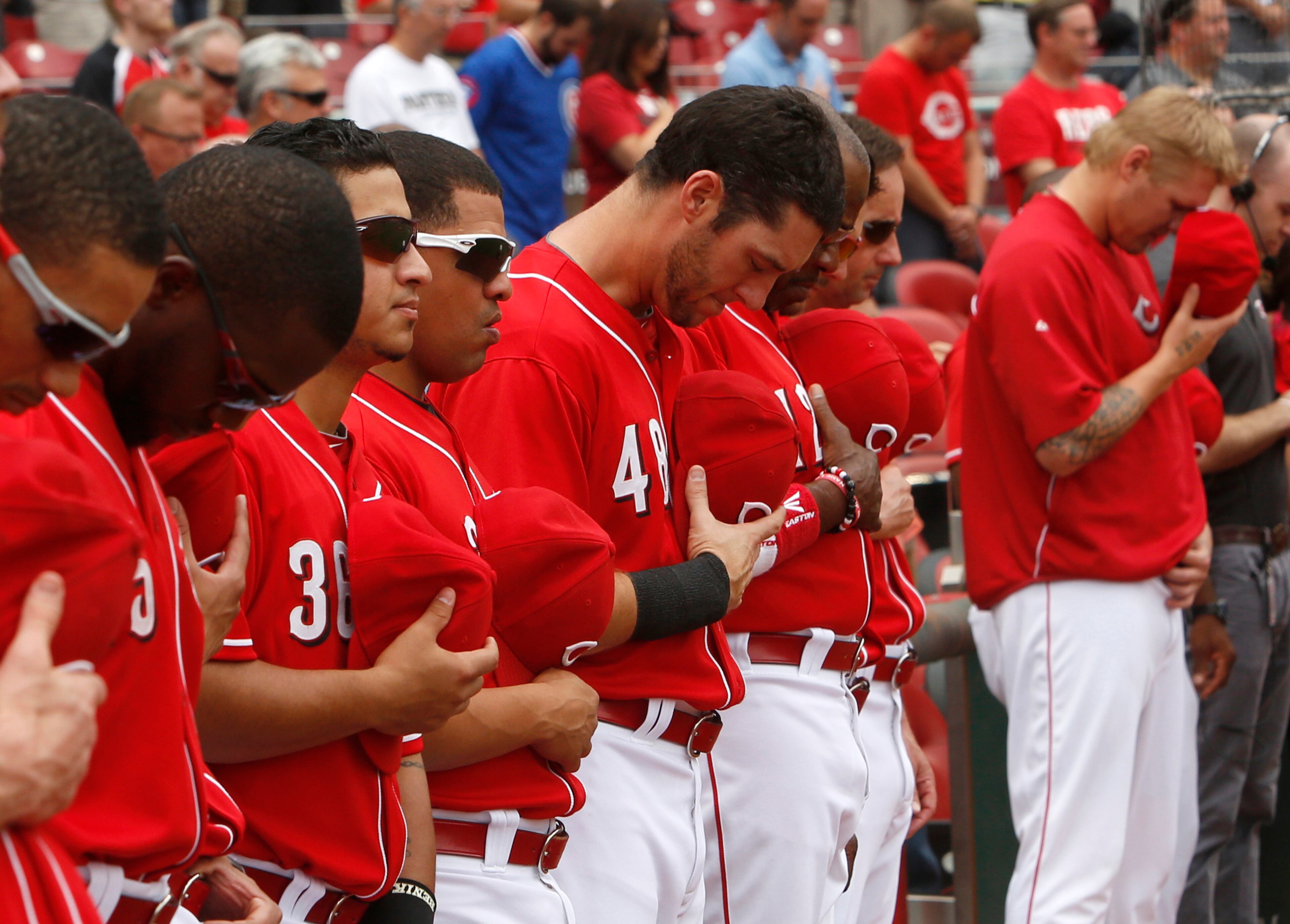 Sep 11, 2013; Cincinnati, OH, USA; Cincinnati Reds players stand during a moment of silence in honor of Patriots Day prior to a game with the Chicago Cubs at Great American Ball Park. Mandatory Credit: David Kohl-USA TODAY Sports