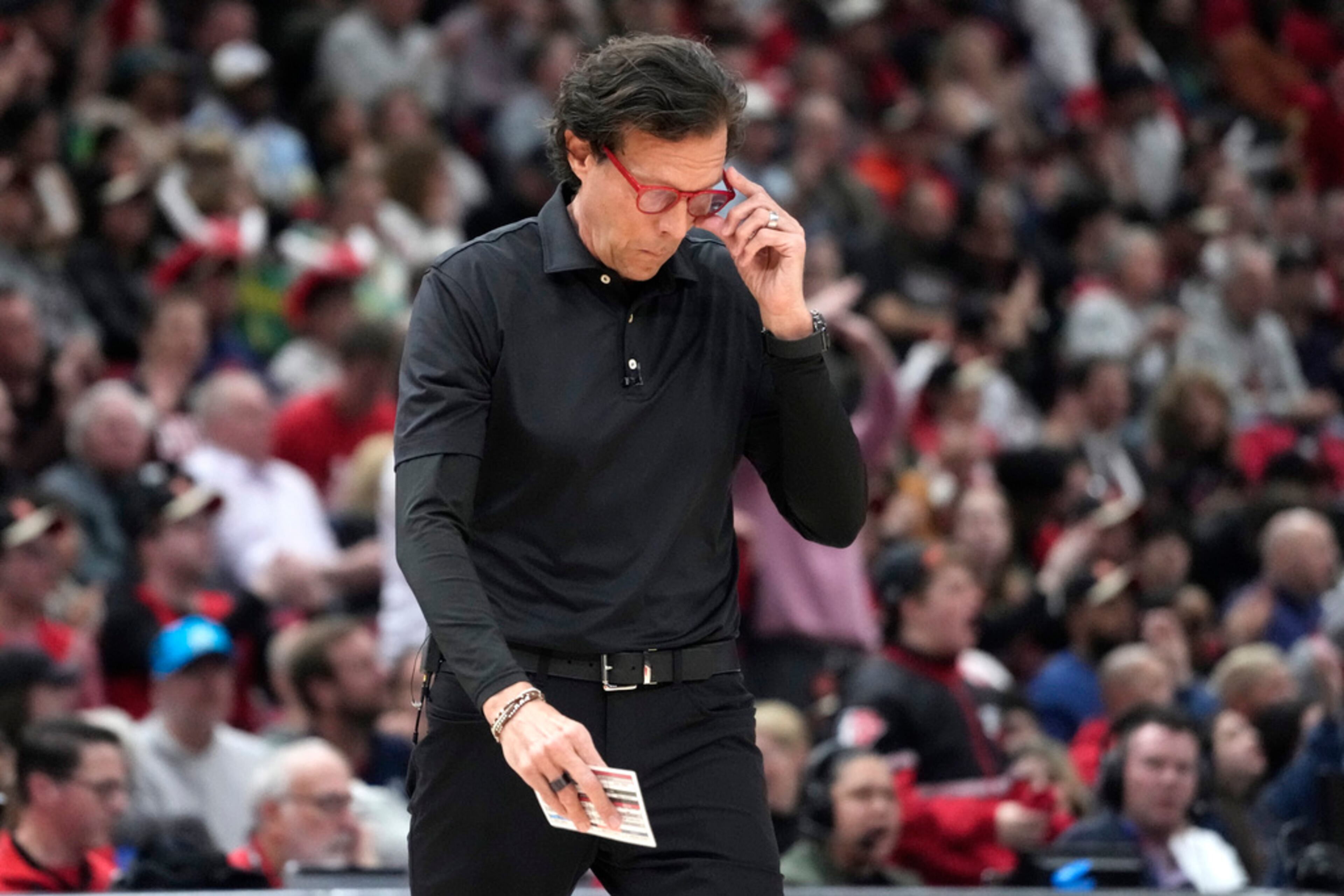 Atlanta Hawks coach Quin Snyder adjusts his glasses during the first half of the team's NBA basketball play-in tournament game against the Chicago Bulls in Chicago, Wednesday, April 17, 2024. (AP Photo/Nam Y. Huh)