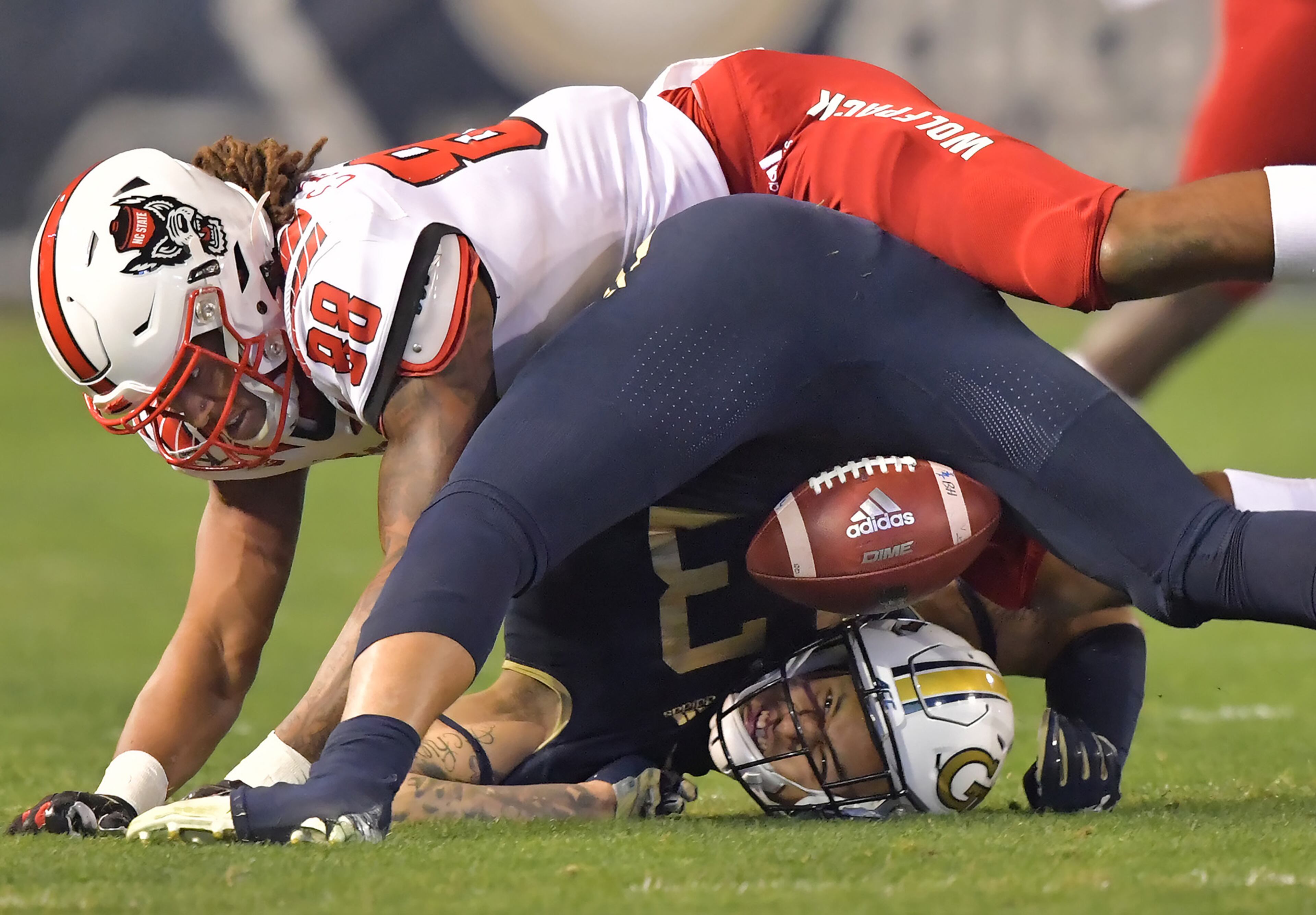 November 21, 2019 Atlanta - Georgia Tech defensive back Avery Showell (13) collides with North Carolina State wide receiver Devin Carter (88) after he blocked a pass during the first half of an NCAA college football game at Bobby Dodd Stadium on Thursday, November 21, 2019. (Hyosub Shin / Hyosub.Shin@ajc.com)