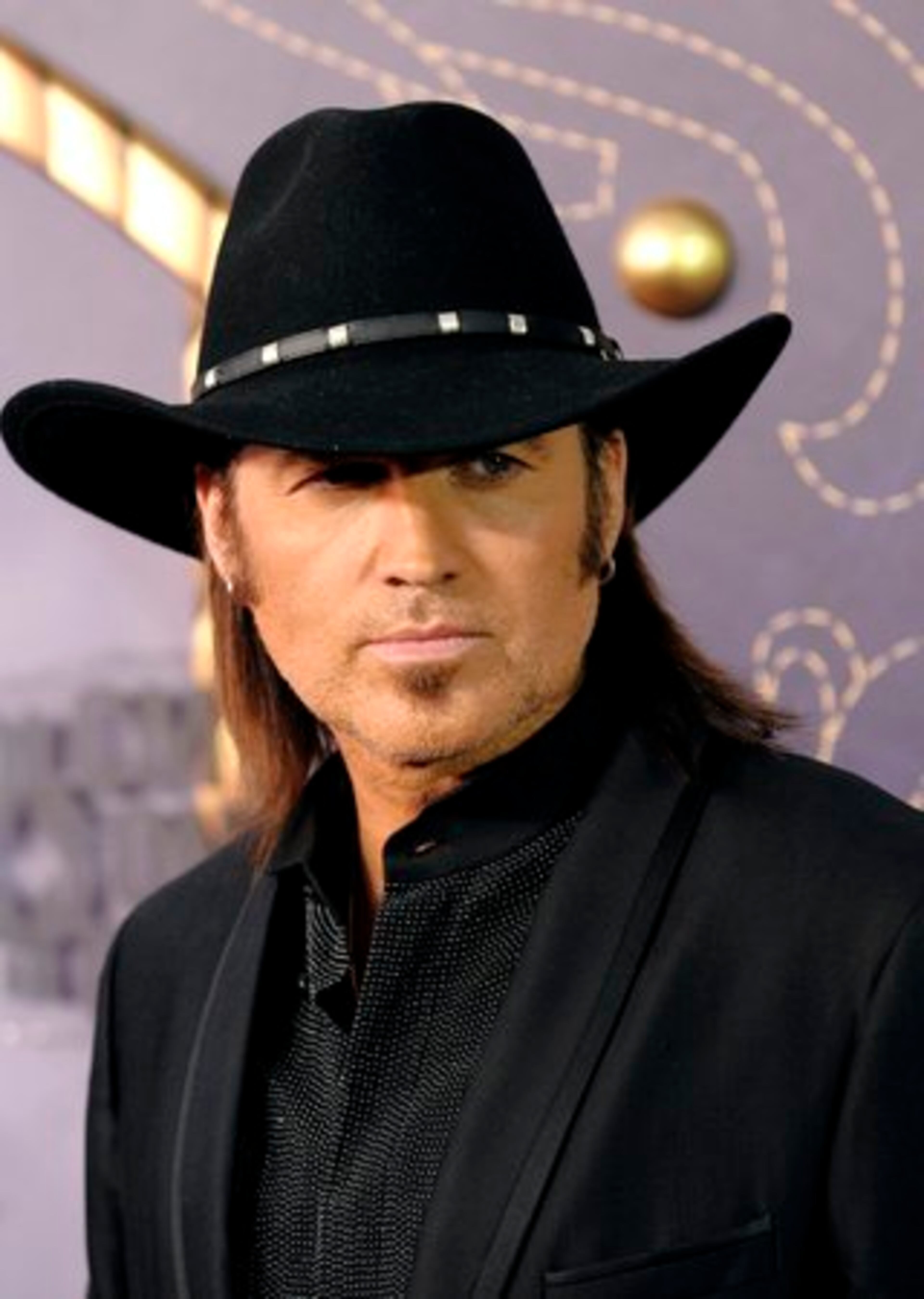 Billy Ray Cyrus, who shared hosting duties with his daughter, tries to pull off his best Johnny Cash impersonation, but he's nowhere near that cool.