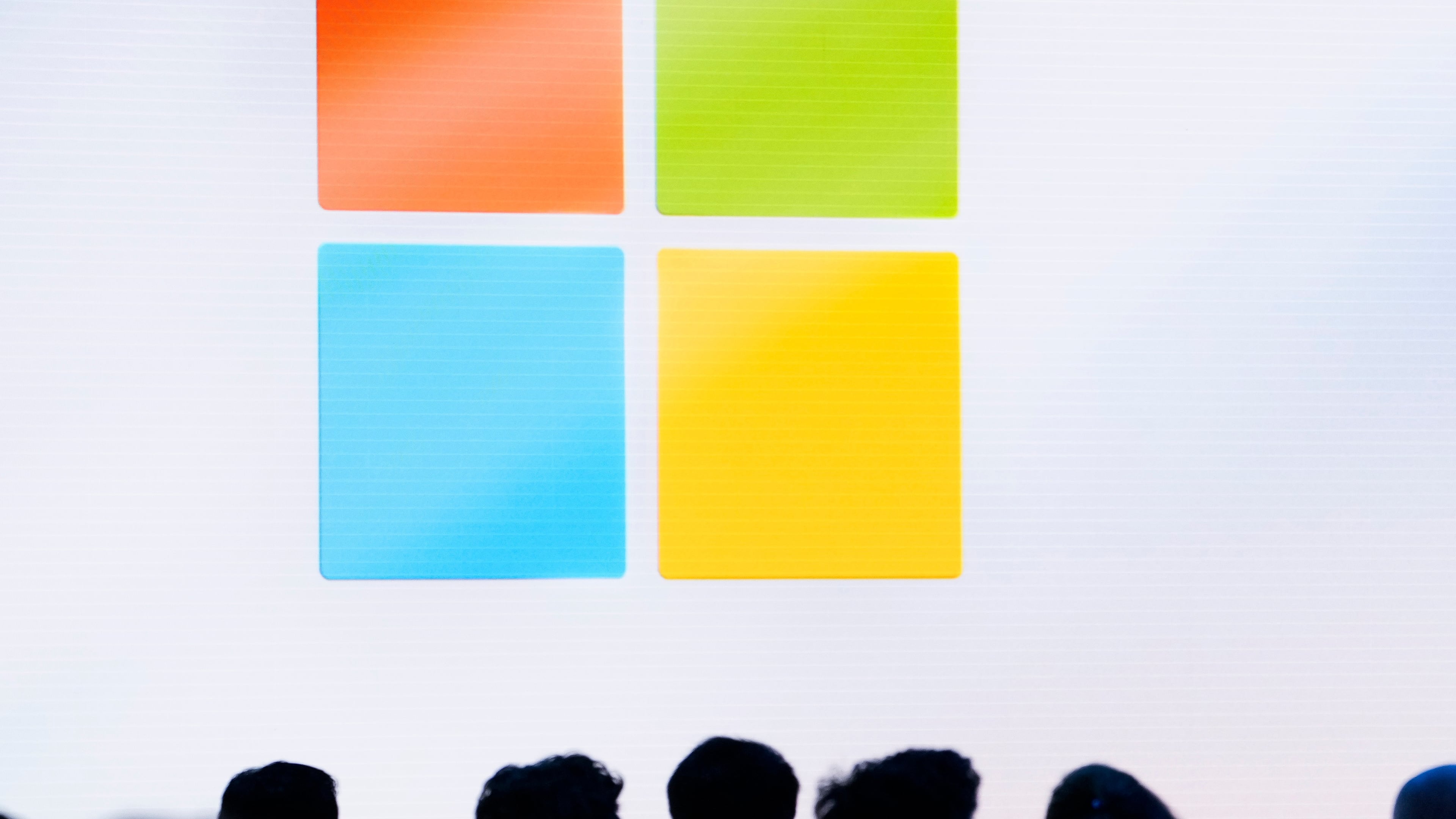 FILE - A Microsoft logo is seen on a screen as people listen at an event at Microsoft headquarters, May 20, 2024, in Redmond, Wash. (AP Photo/Lindsey Wasson, File)