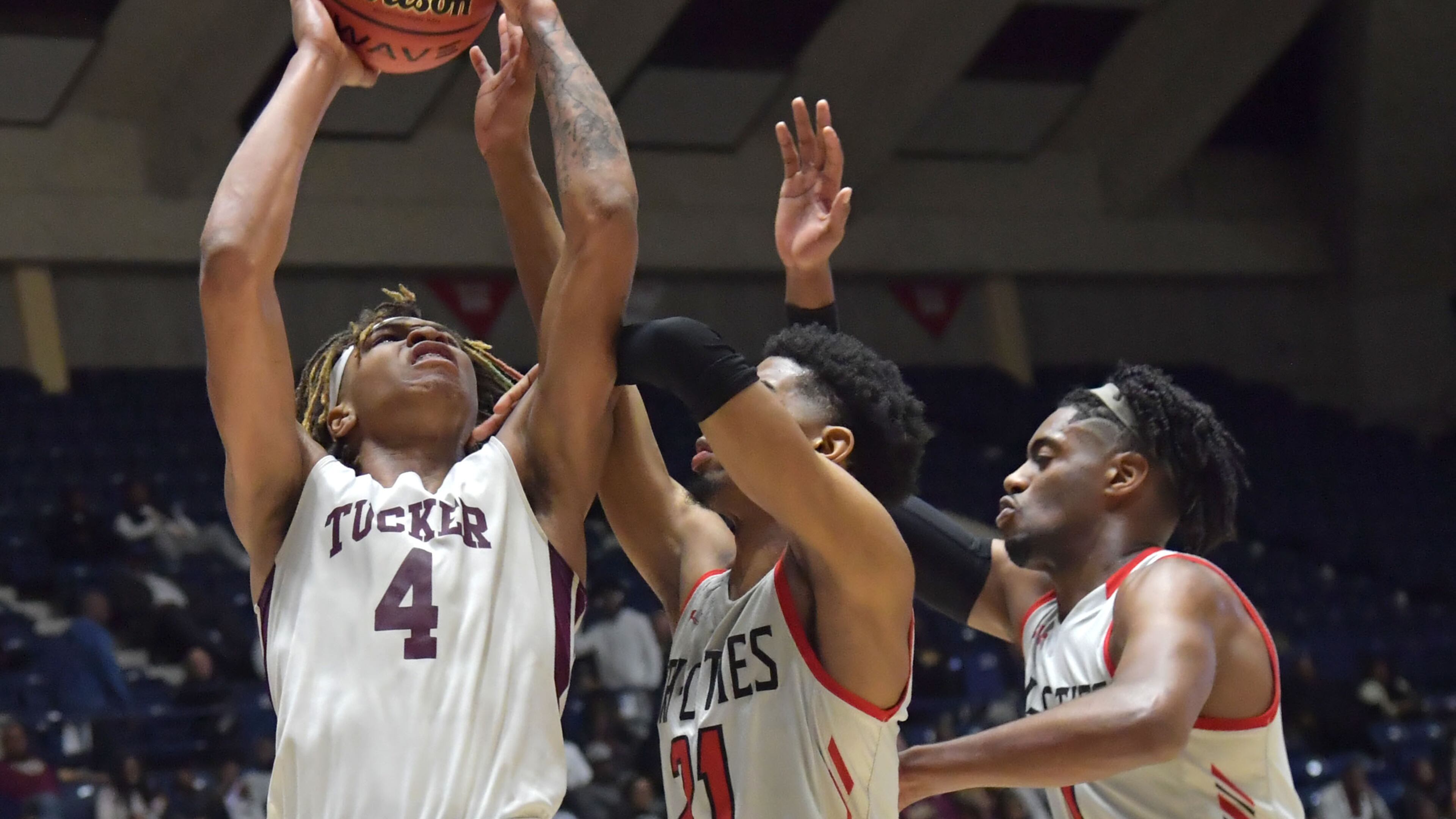March 9, 2019 Macon - Tucker Montae Hall (4) shoots against Tri-Cities Eli'sha King (21) in GHSA State Basketball Championship game at the Macon Centreplex in Macon on Saturday, March 9, 2019. HYOSUB SHIN / HSHIN@AJC.COM