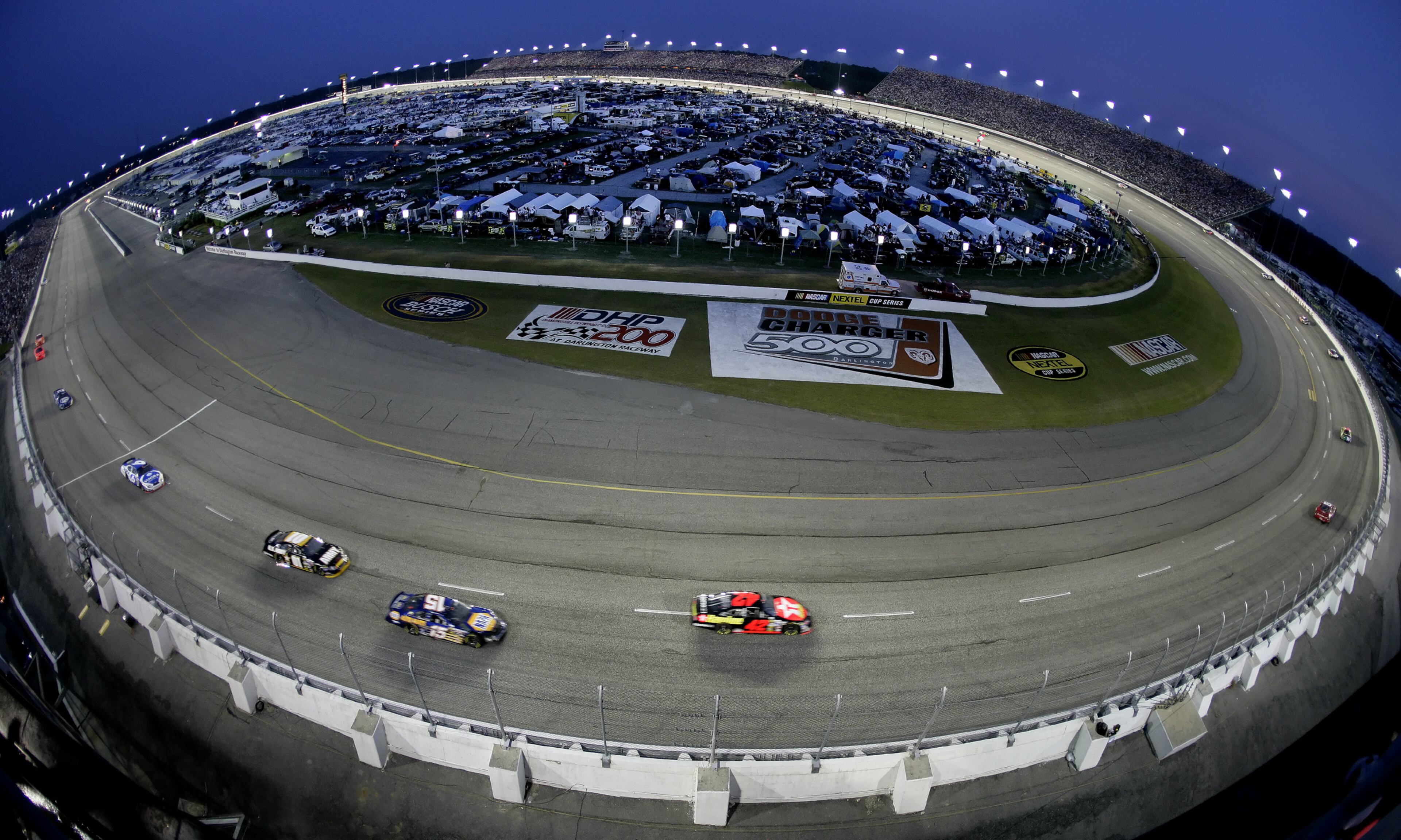 Cars race around the Darlington Speedway in Darlington, S.C., during the Dodge Charger 500, in this May 7, 2005, file photo. Darlington Raceway president Chris Browning said Wednesday, July 6, 2005, that the track got the go-ahead from its owners, International Speedway Corp., to send out ticket renewal letters for another Mother's Day weekend Nextel Cup race. The date of the Carolina Dodge Dealers 500 is May 13, 2006, the night before Mother's Day. (AP Photo/Dave Martin, File)