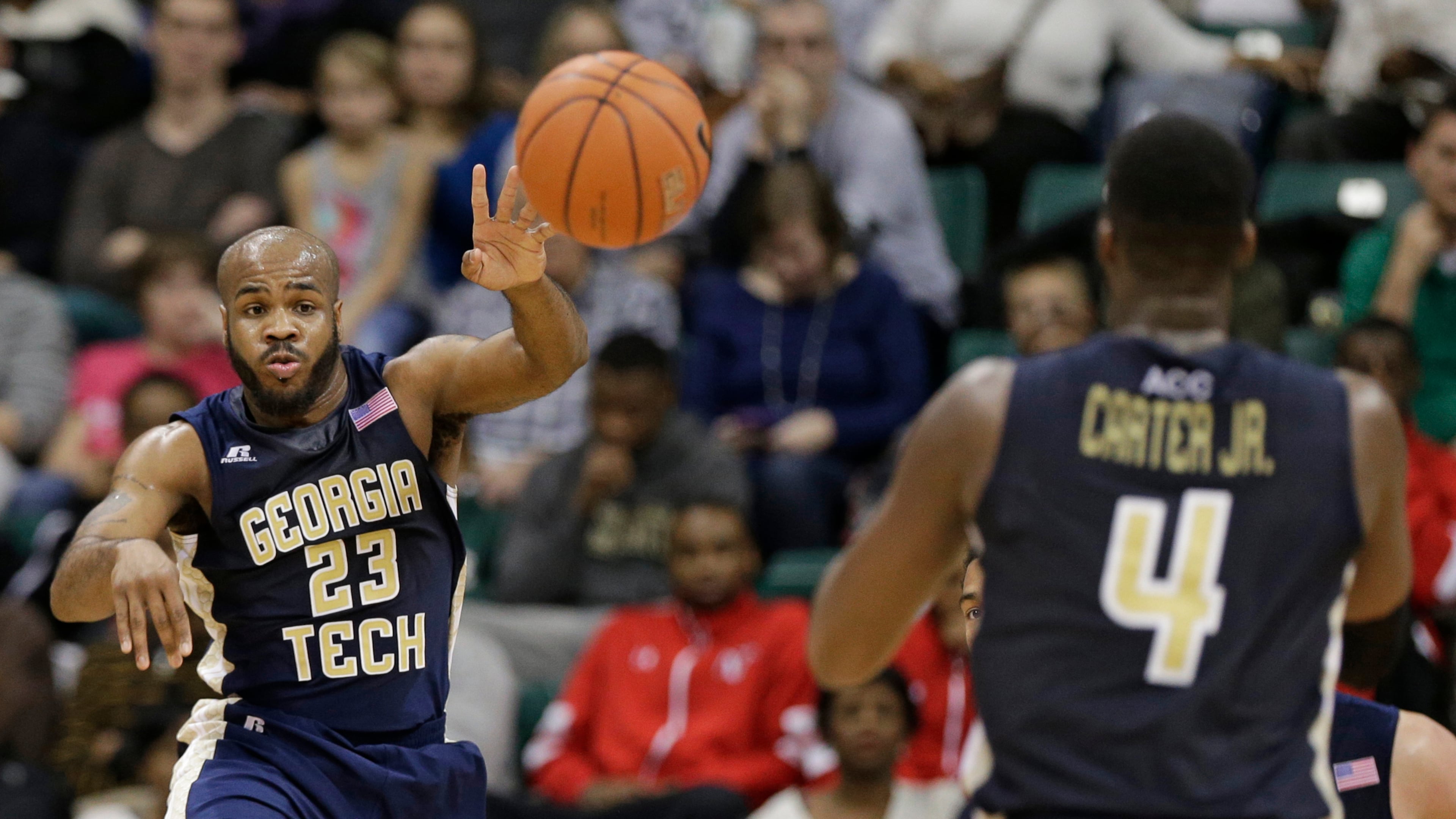 Georgia Tech's Trae Golden (23) passes the ball to Robert Carter, Jr. (4) during the first half of an NCAA college basketball game against Charlotte in Charlotte, N.C., Sunday, Dec. 29, 2013. (AP Photo/Chuck Burton)