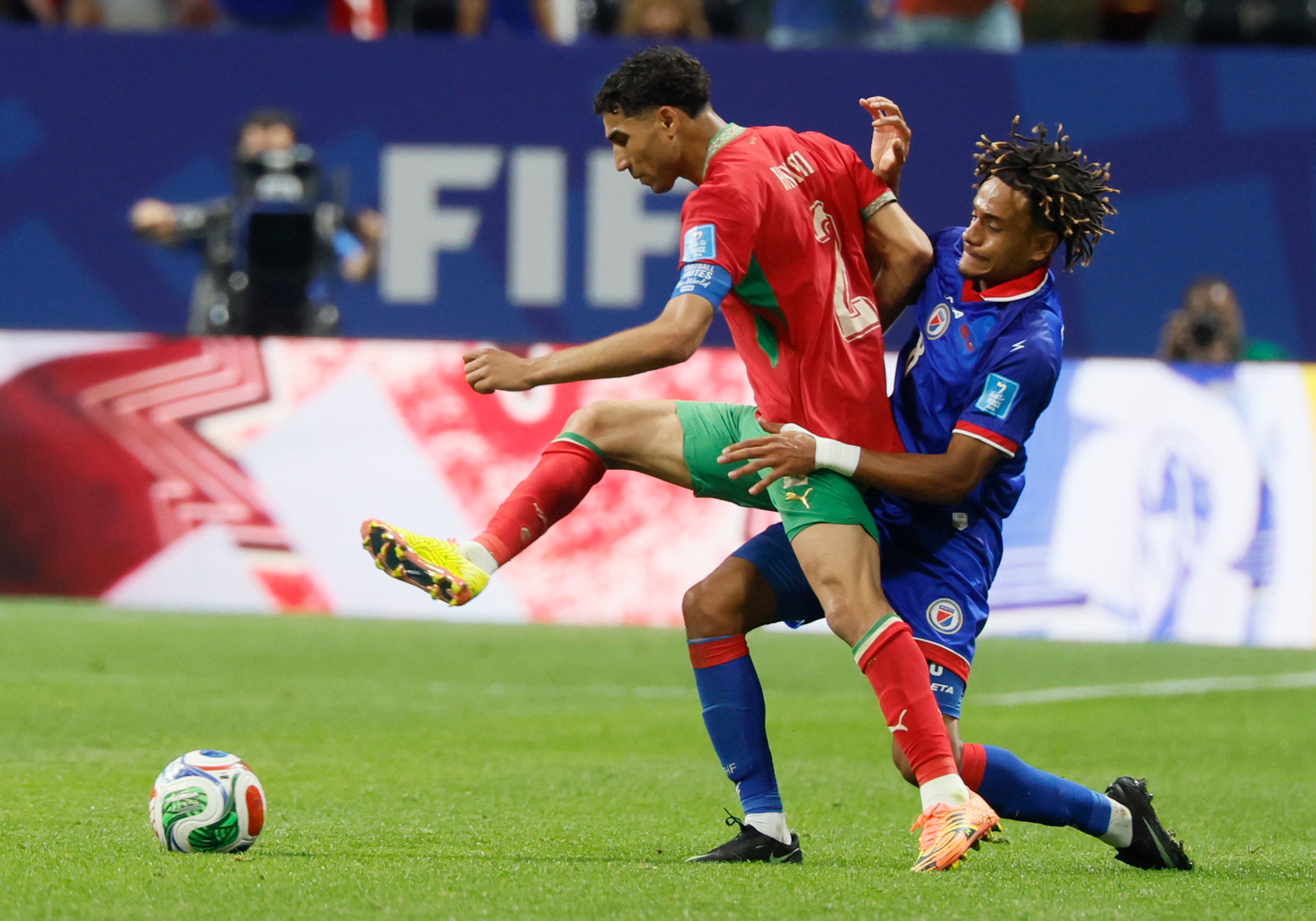 Morocco's Achraf Hakimi, left, battles Haiti's Martin Experience during second half of Morocco vs. Haiti Group C FIFA World Cup match at Atlanta Stadium (Mercedes-Benz Stadium) on Wednesday, June 24, 2026. (Miguel Martinez/AJC)