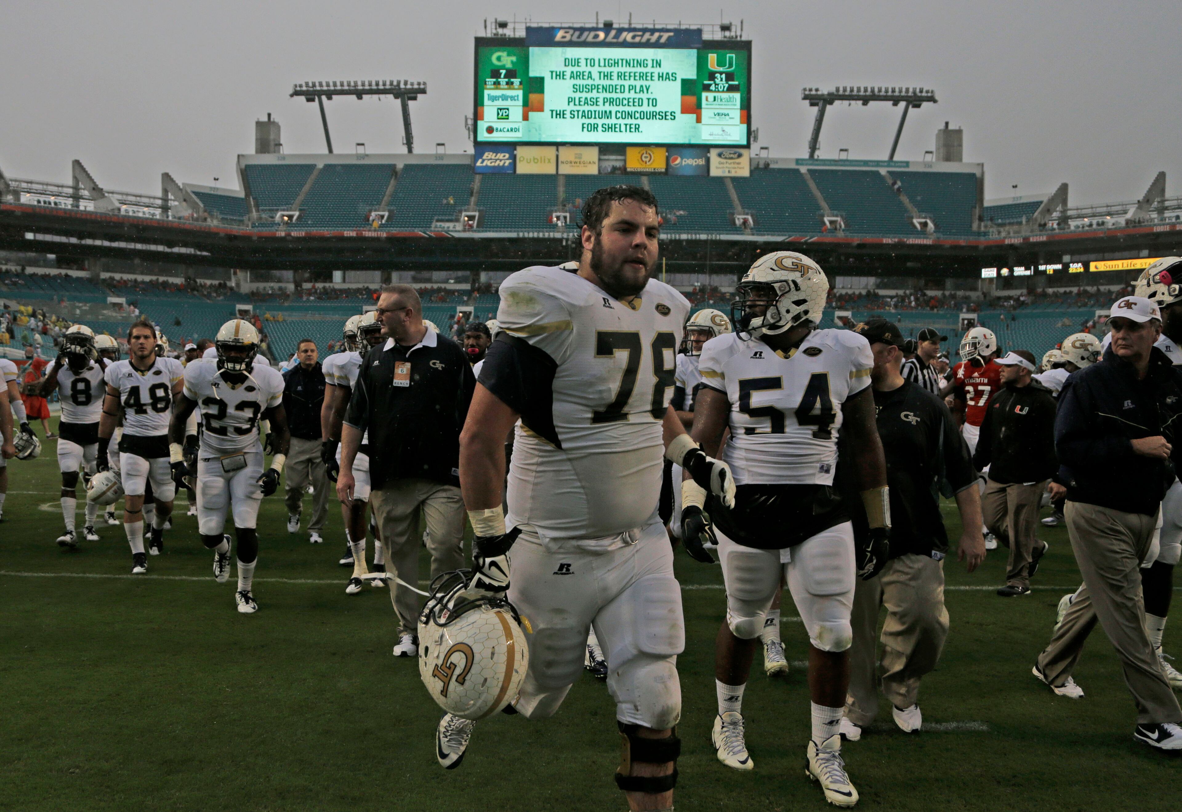 Georgia Tech offensive lineman Trey Braun (78) leaves the field with his teammates after play was suspended due to lightning in the area in the third quarter of an NCAA college football game against Miami, Saturday, Nov. 21, 2015, in Miami Gardens, Fla. (AP Photo/Lynne Sladky)