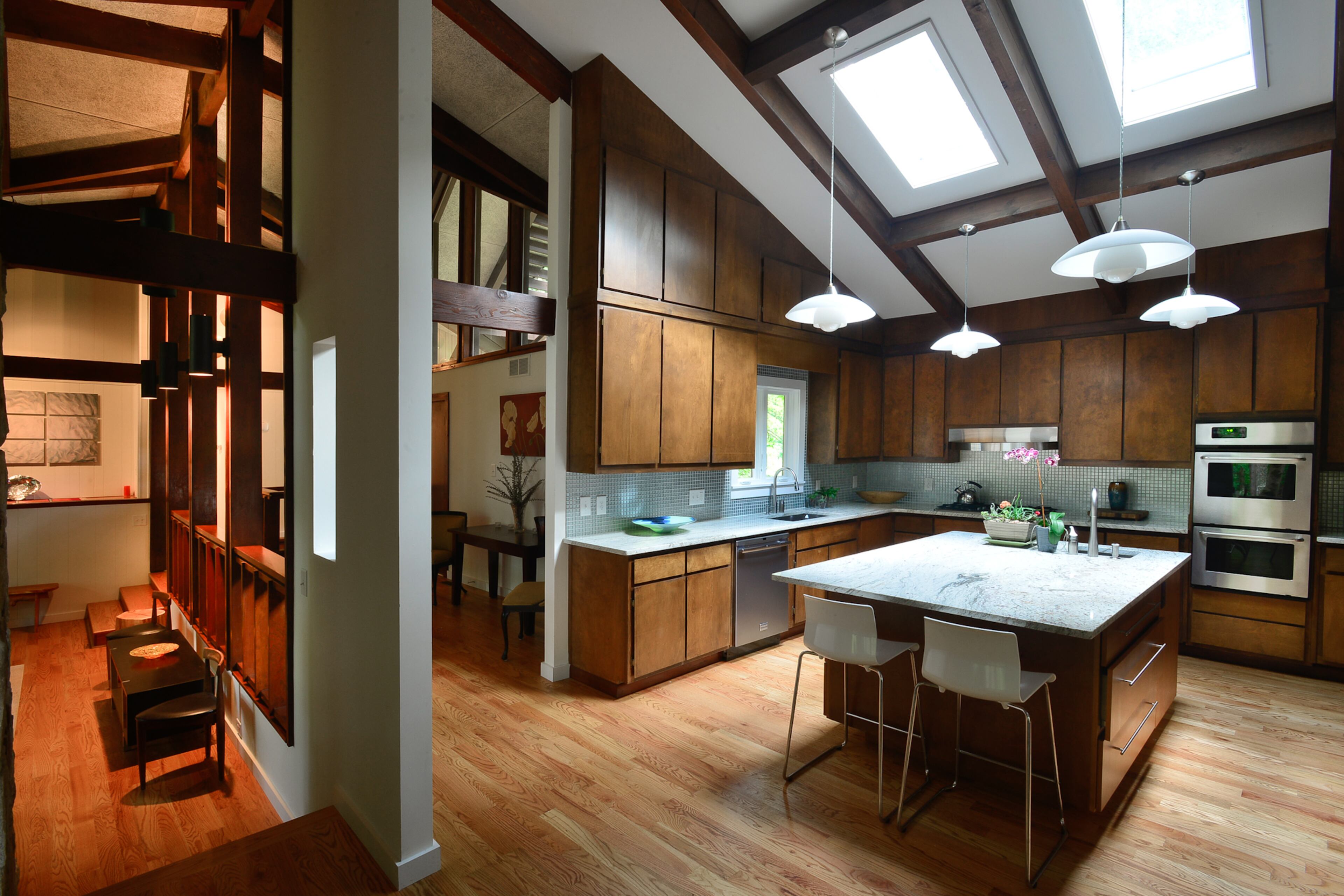 The kitchen had been boxed off, but the homeowners saw the potential in being able to open the kitchen up to the rest of the living area. The homeowners say they love that the home's design has a transparent element.