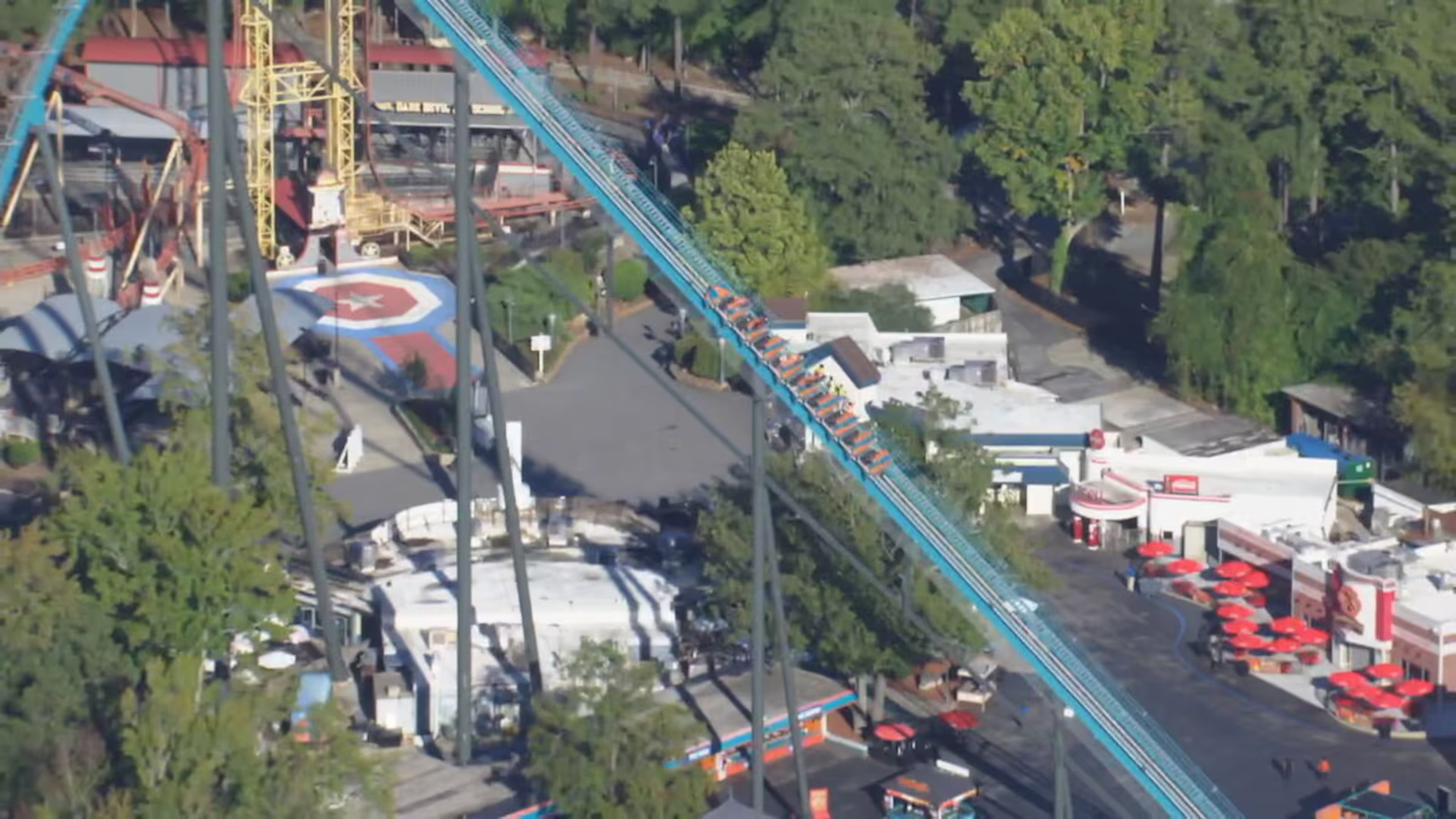 Riders on the Goliath roller coaster at Six Flags over Georgia in Austell are evacuated by park personnel on Monday, Oct. 12, 2026. One person died and several others were injured in “an incident involving a roller coaster” at Six Flags Over Georgia, Cobb County Police said Monday evening. (Courtesy WSB-TV)