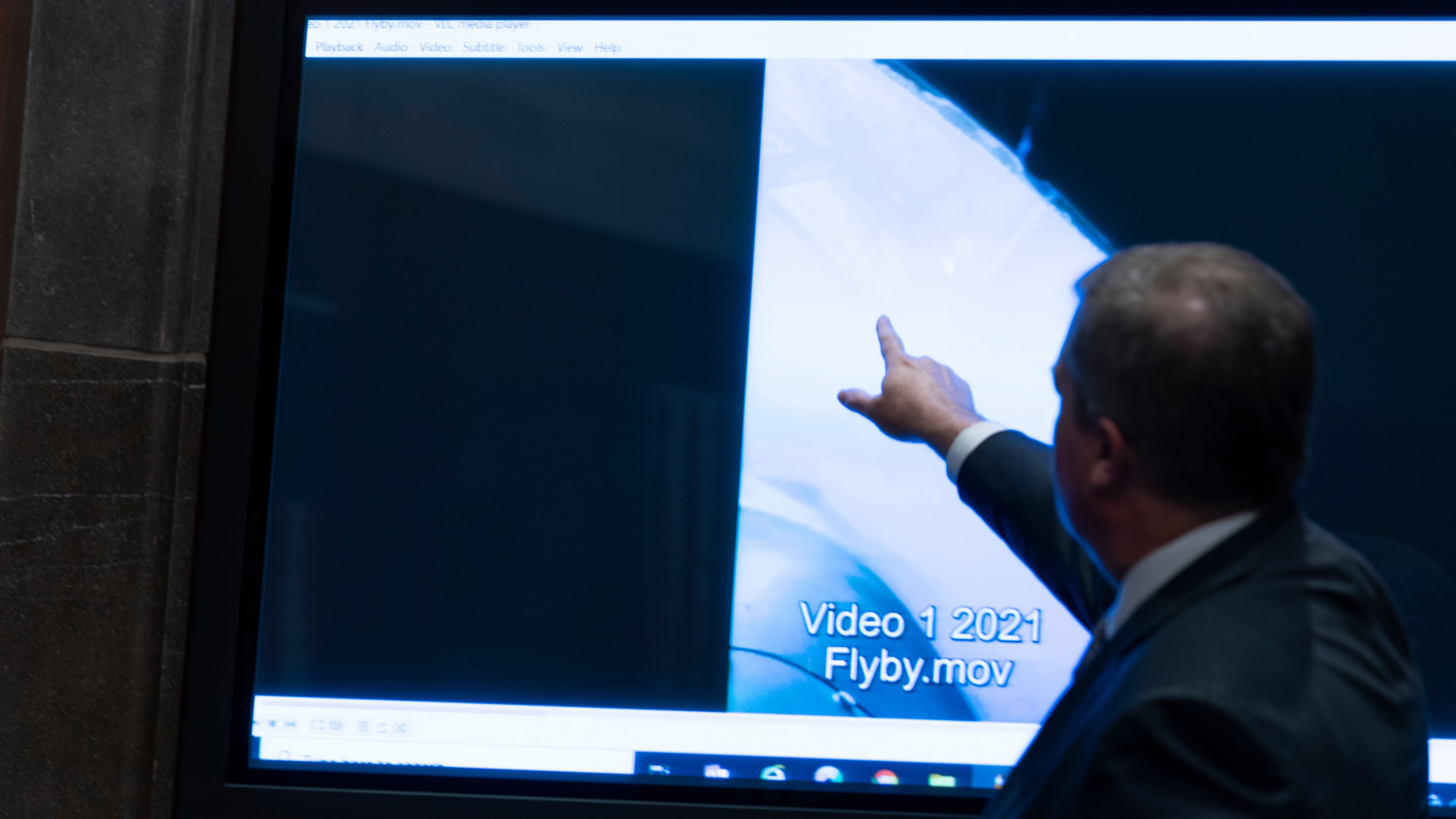 FILE - Deputy Director of Naval Intelligence Scott Bray points to a video display of a UAP during a hearing of the House Intelligence, Counterterrorism, Counterintelligence, and Counterproliferation Subcommittee hearing on "Unidentified Aerial Phenomena," on Capitol Hill, May 17, 2022, in Washington. (AP Photo/Alex Brandon, File)
