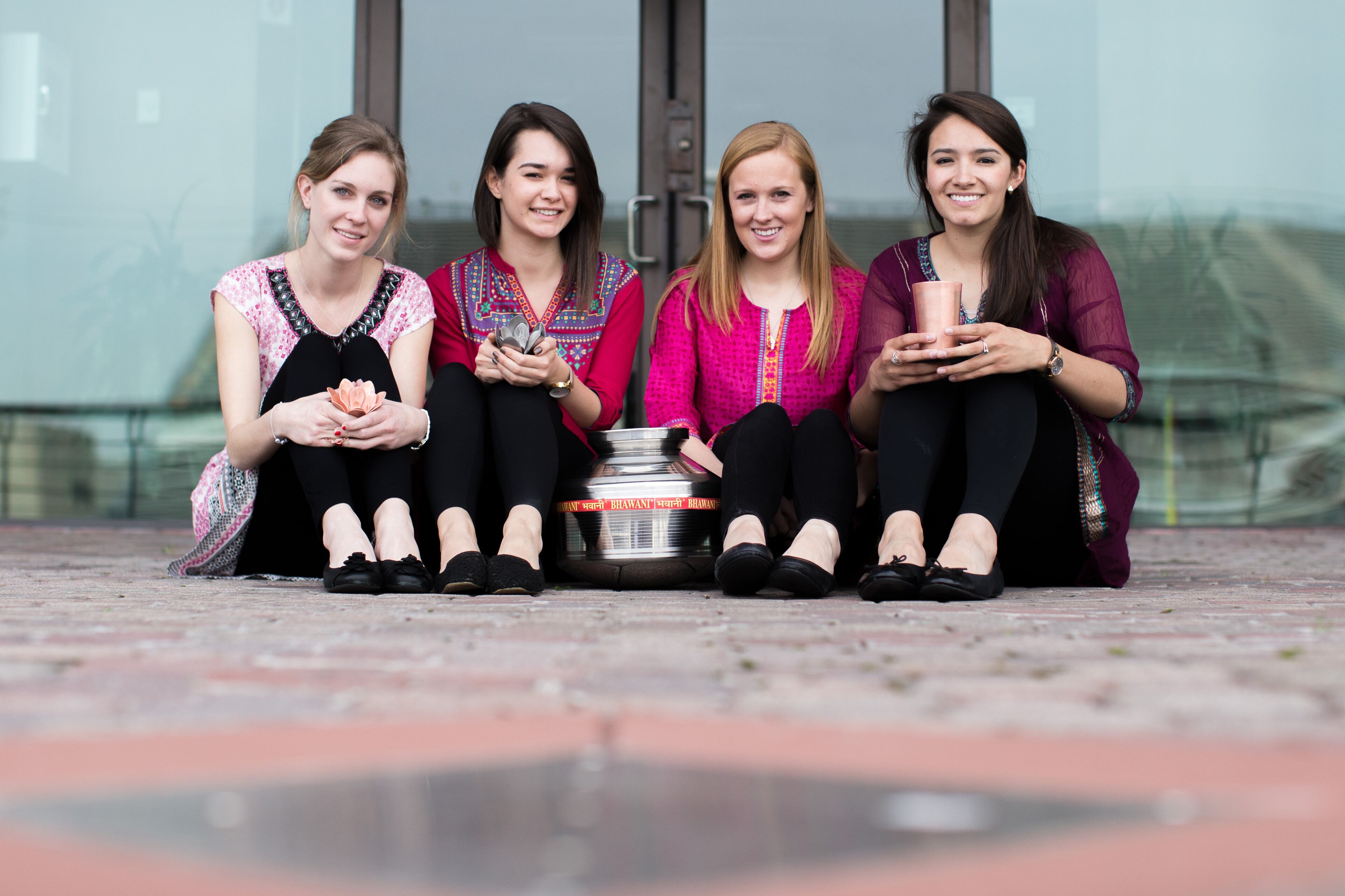 Georgia Tech students (from left) Samantha Becker, Naomi Ergun, Shannon Evanchec and Sarah Lynn Bowen, pose for a photo with their product, TruPani, an invention that kills harmful microbes in drinking wate. TruPani includes a passive antimicrobial cup and water storage device. BRANDEN CAMP/SPECIAL