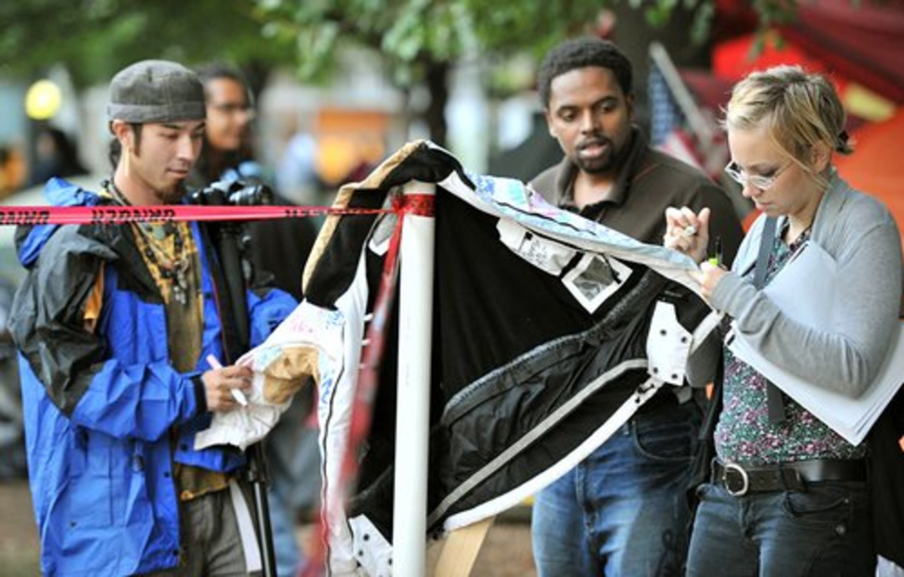 Jessica Holdbrooks (right), of Kennesaw, writes a message on a message jacket.