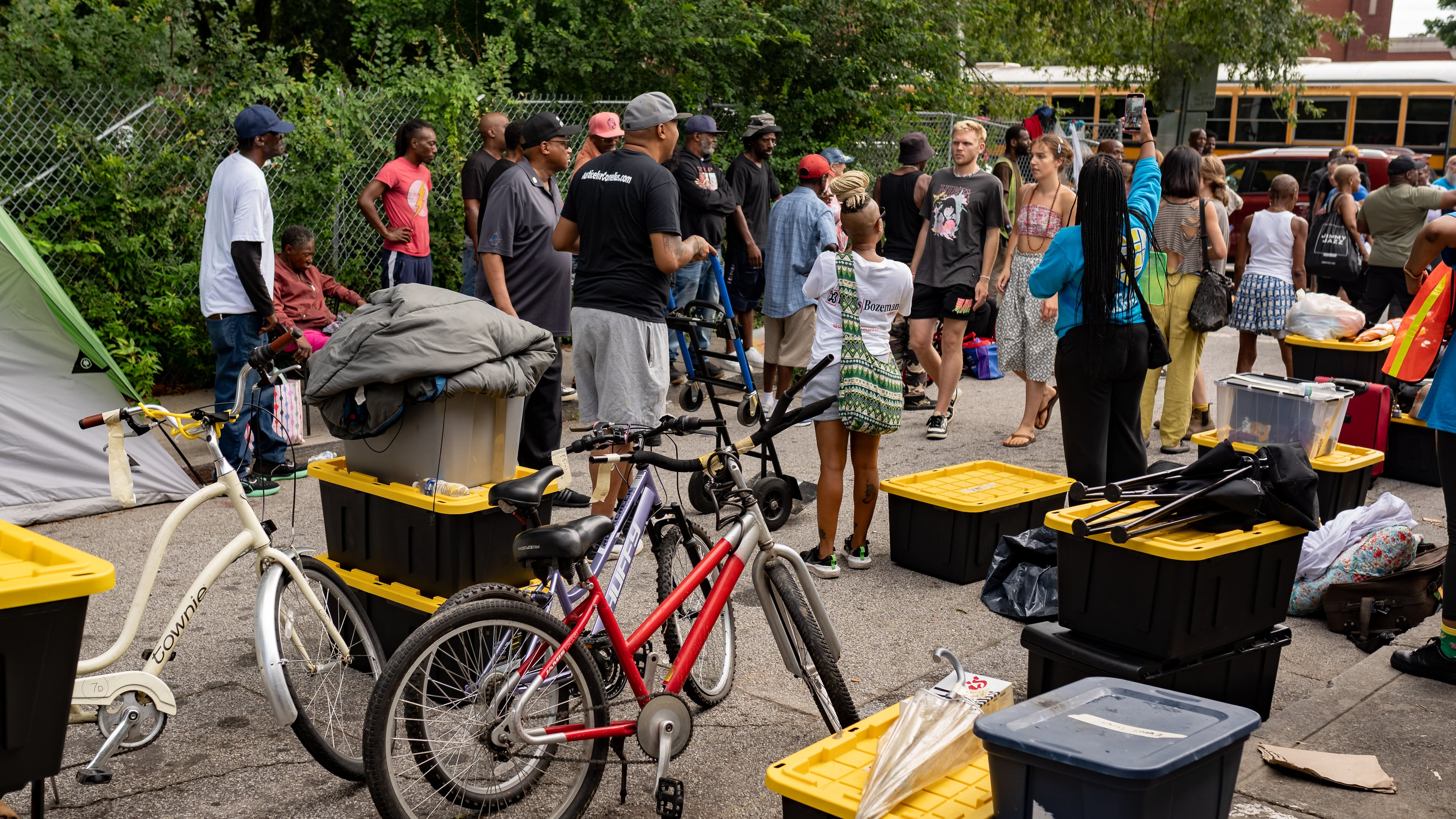 A bus waits to move over 20 homeless people from the Old Wheat Street encampment to Welcome House on Thursday, July 10, 2025. Atlanta has long treated homelessness not as a structural failure but as a public nuisance to be hidden and criminalized, writes AJC guest columnist Carson Bohl. (Ben Hendren for the AJC)
