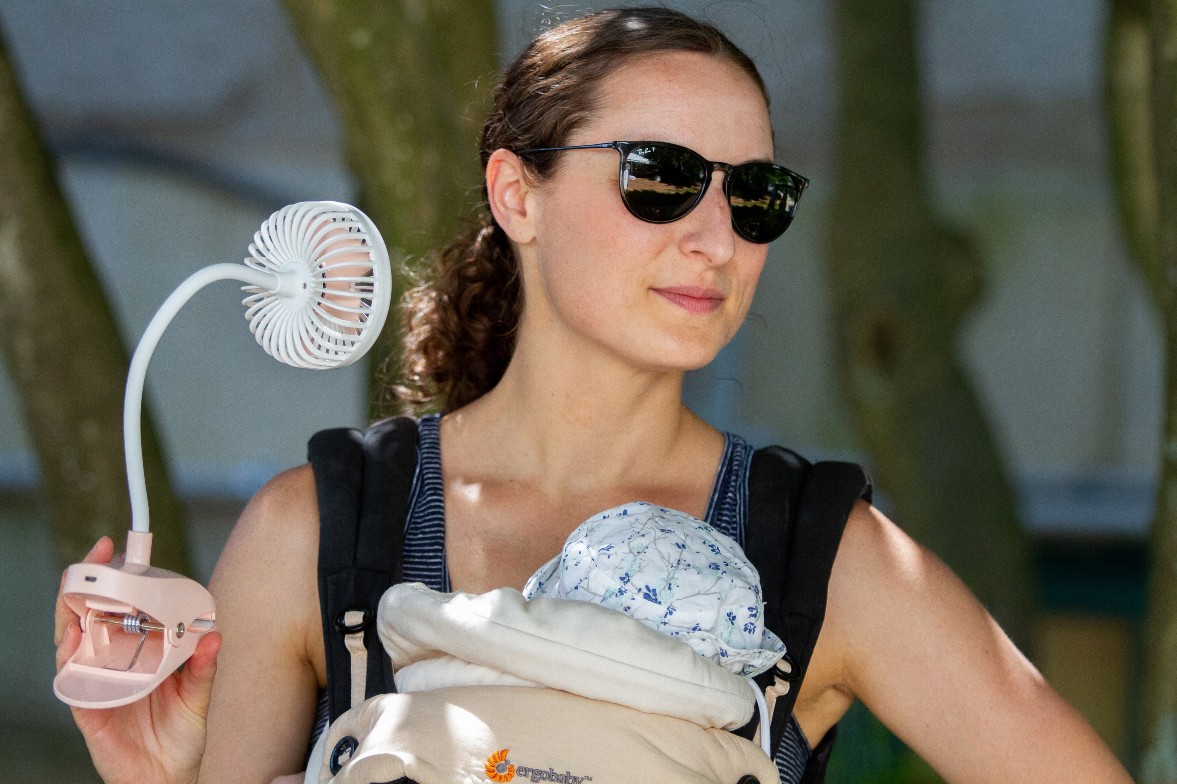 Alisha Roberts tries to cool herself and her daughter Maisie with a handheld fan during the annual Decatur Arts Festival on Sunday, May 26, 2019. .STEVE SCHAEFER / SPECIAL TO THE AJC