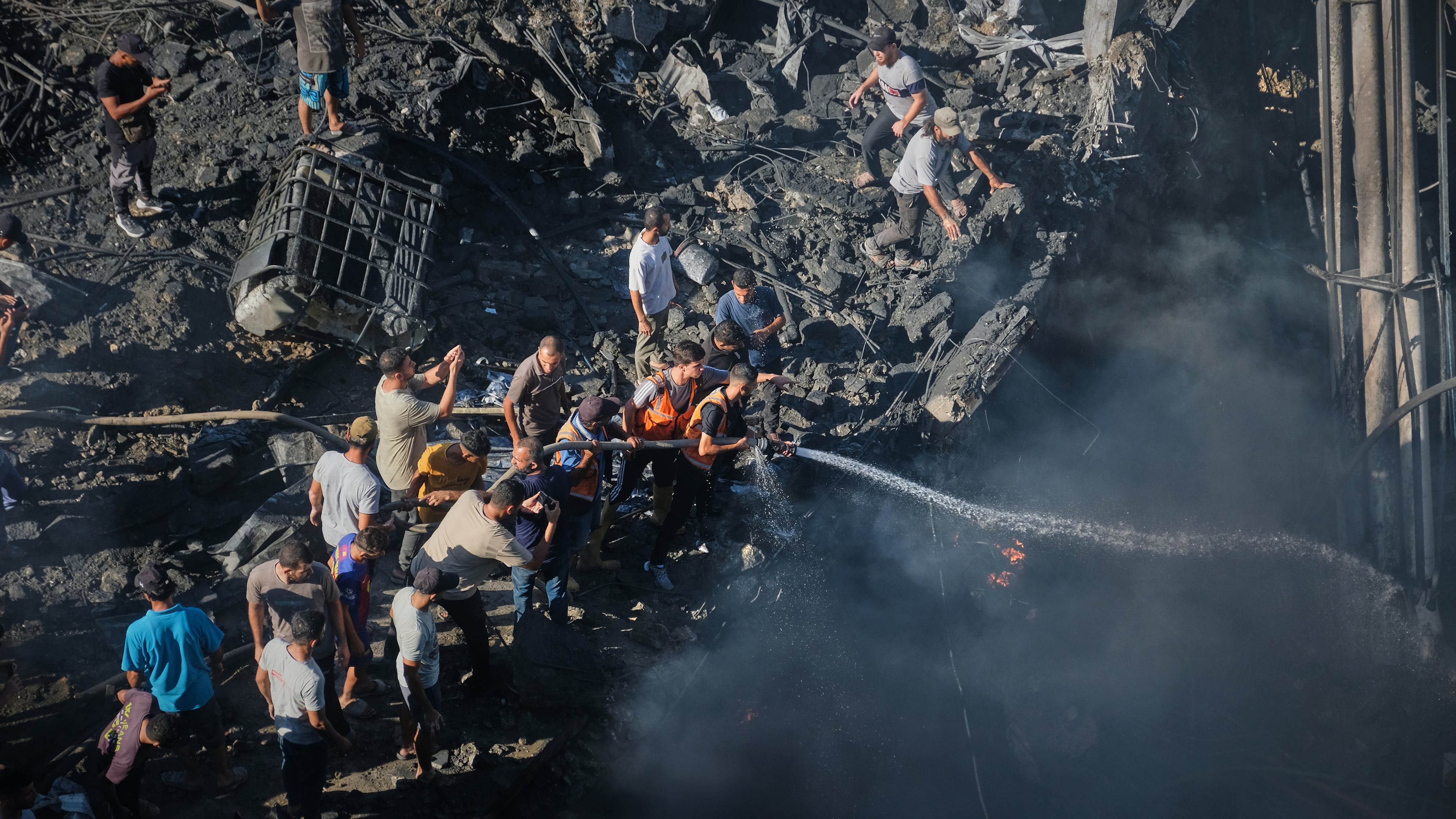 Palestinians try to extinguish a fire in the rubble of a destroyed building following an Israeli airstrike in Gaza City, Monday, Aug. 24, 2026. (AP Photo/Jehad Alshrafi)