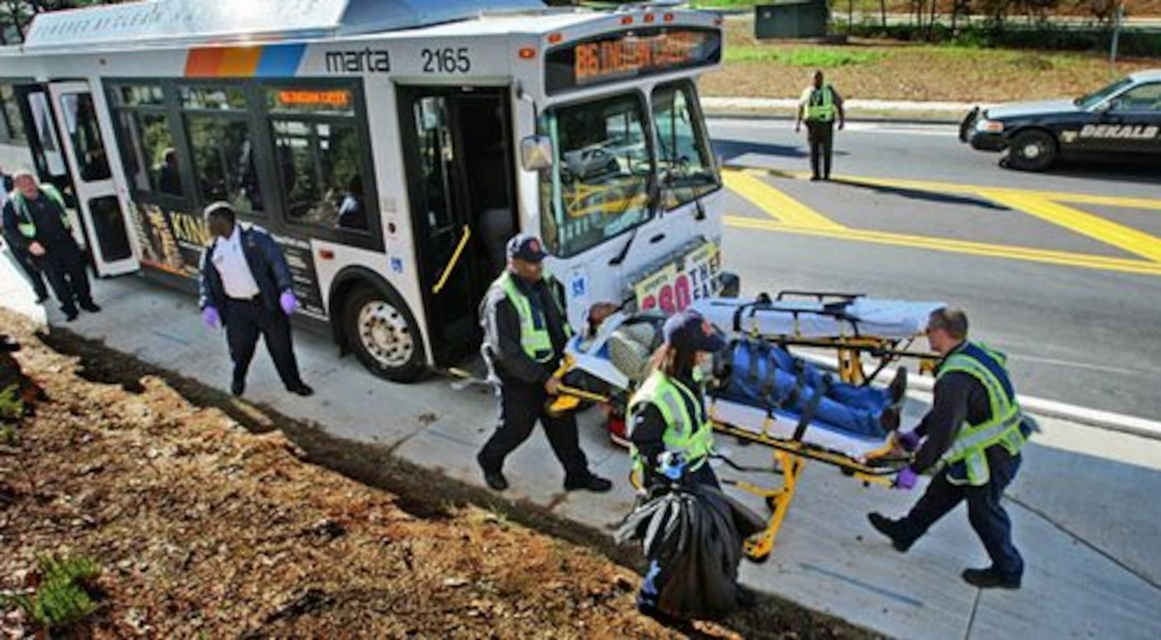 A patient is wheeled on a stretcher after a MARTA bus and a car collided in Lithonia Monday morning. Only minor injuries were reported.
