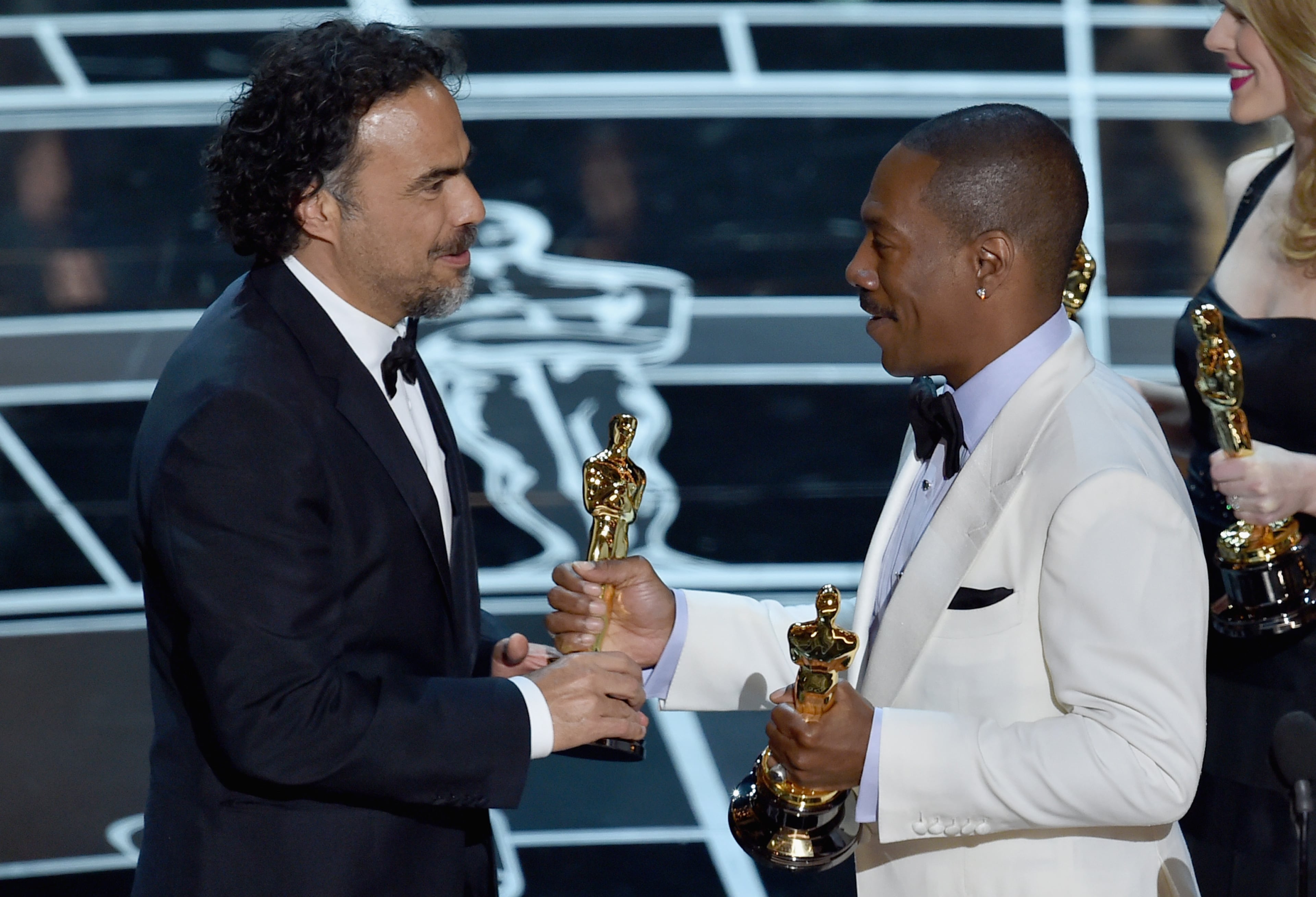 Screenwriter Alejandro Gonzalez Inarritu accepts Best Original Screenplay Award for "Birdman" from actor Eddie Murphy onstage during the 87th Annual Academy Awards at Dolby Theatre on February 22, 2015 in Hollywood, California. (Photo by Kevin Winter/Getty Images)