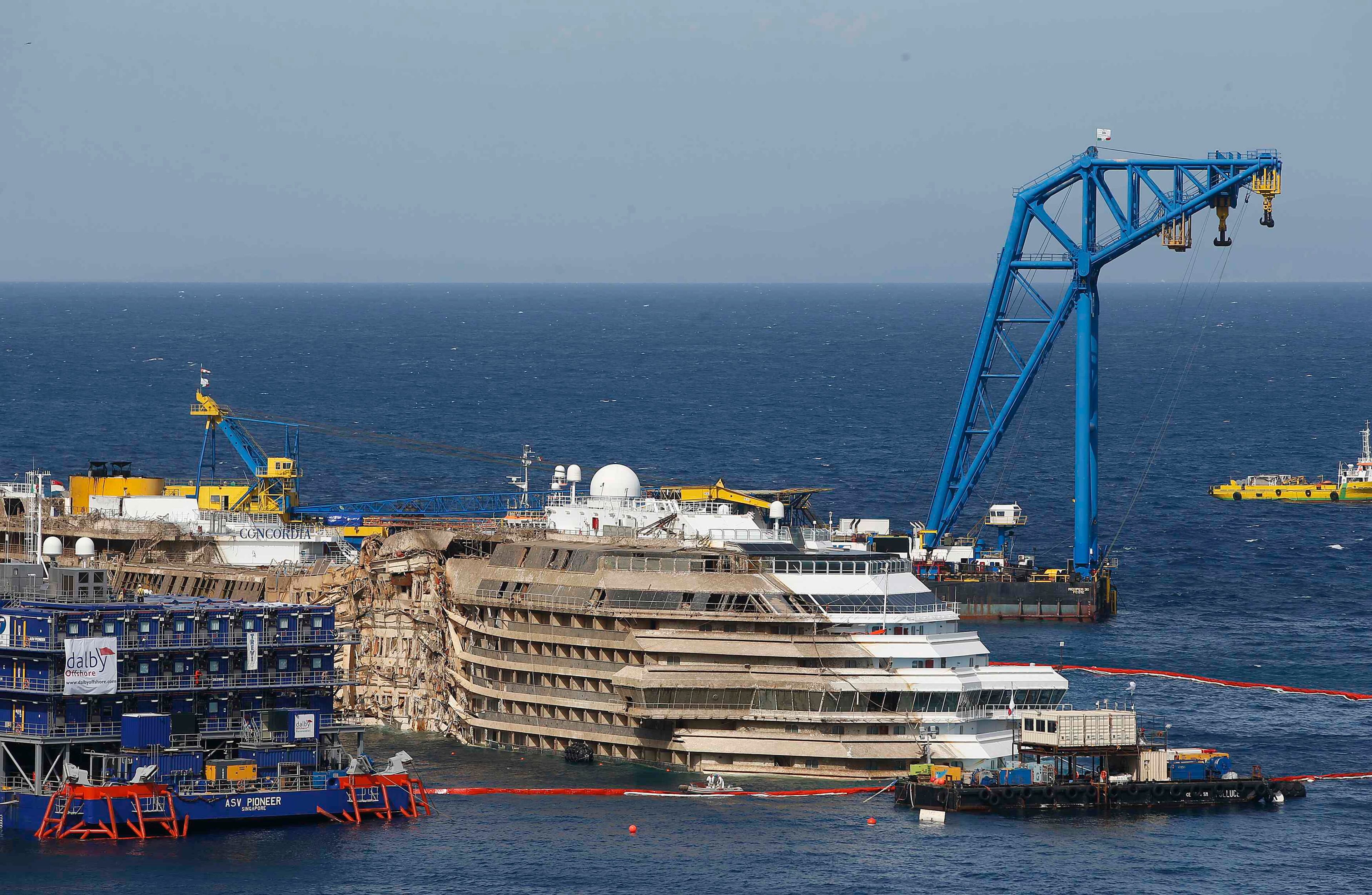 The capsized cruise liner Costa Concordia is seen at the end of the "parbuckling" operation outside Giglio harbour September 17, 2013. Salvage crews completed raising the wreck of the Costa Concordia in the early hours of Tuesday morning after a 19-hour-long operation on the Italian island of Giglio where the huge cruise liner capsized in January last year.REUTERS/Tony Gentile