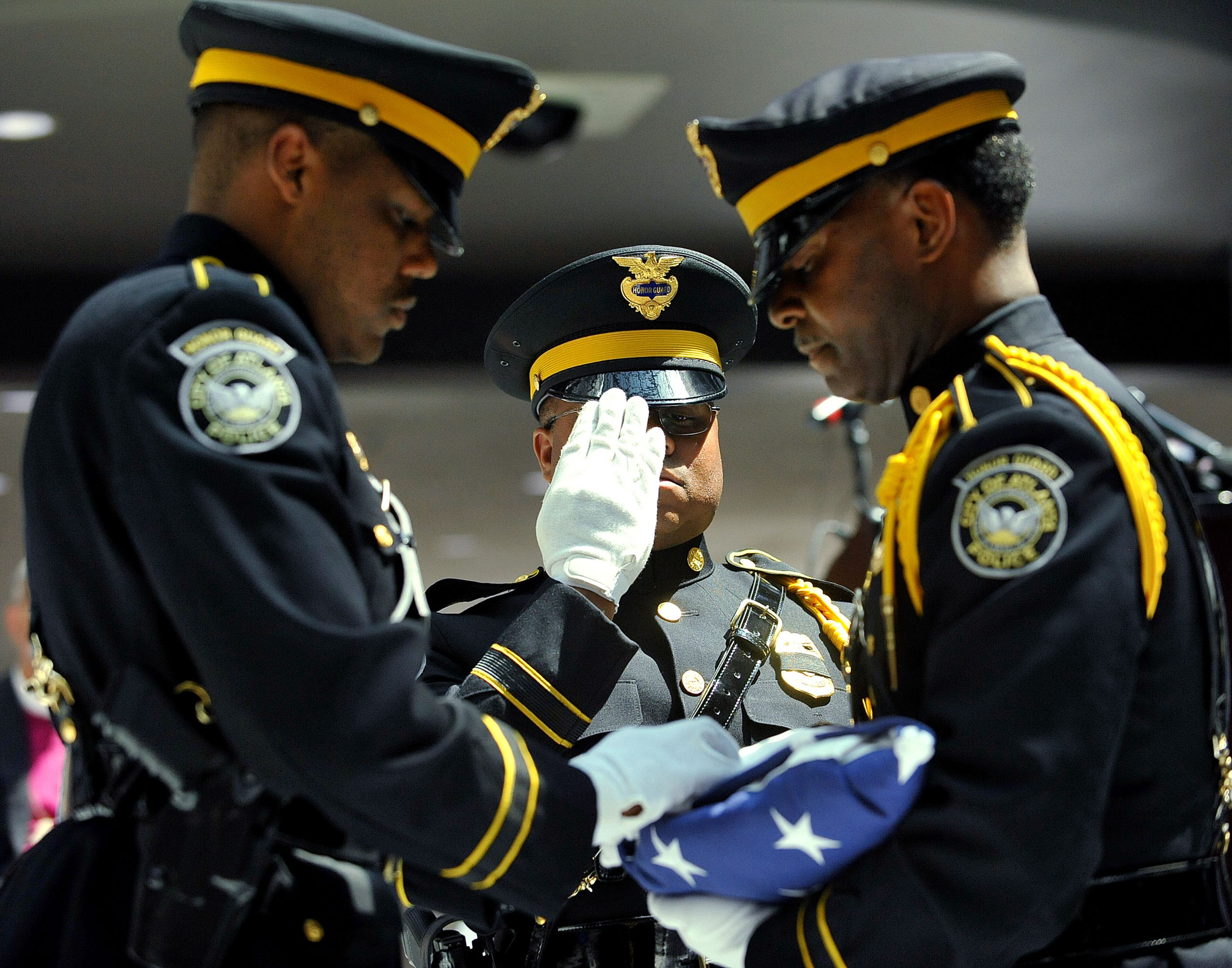APD Honor Guard members Officer D.T Hannah (from left), Officer Dwayne Hilton and SPO Keech Boyd finish the folding of the flag during the service. The Atlanta Police Department recognized 82 fallen officers during the 24th Annual Police Memorial Service at the Atlanta City Hall atrium, Tuesday, May 5, 2015. The Right Rev. Robert C. Wright of the Episcopal Diocese of Atlanta was the keynote speaker. Additional speakers included Atlanta Police Chief George N. Turner, Michael Geisler, Chief Operating Officer, City Council President Ceasar C. Mitchell and Council member C.T. Martin, Public Safety Chair. KENT D. JOHNSON /KDJOHNSON@AJC.COM