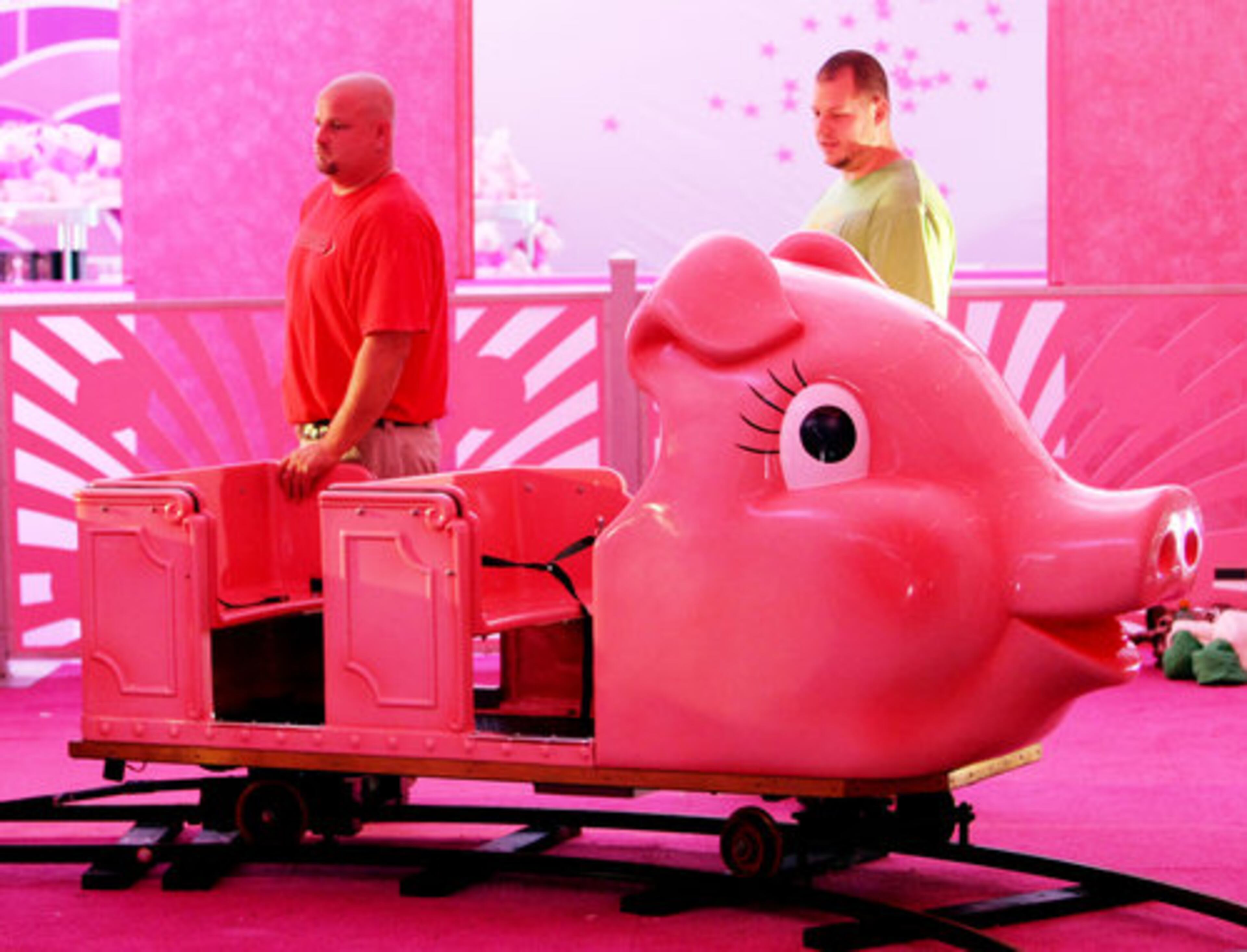 Steven Swofford and his brother Josh check out one of the cars. The pink train rolls through a giant storybook of faux snowscapes that include the Priscilla the Pig and Richie Bear characters.