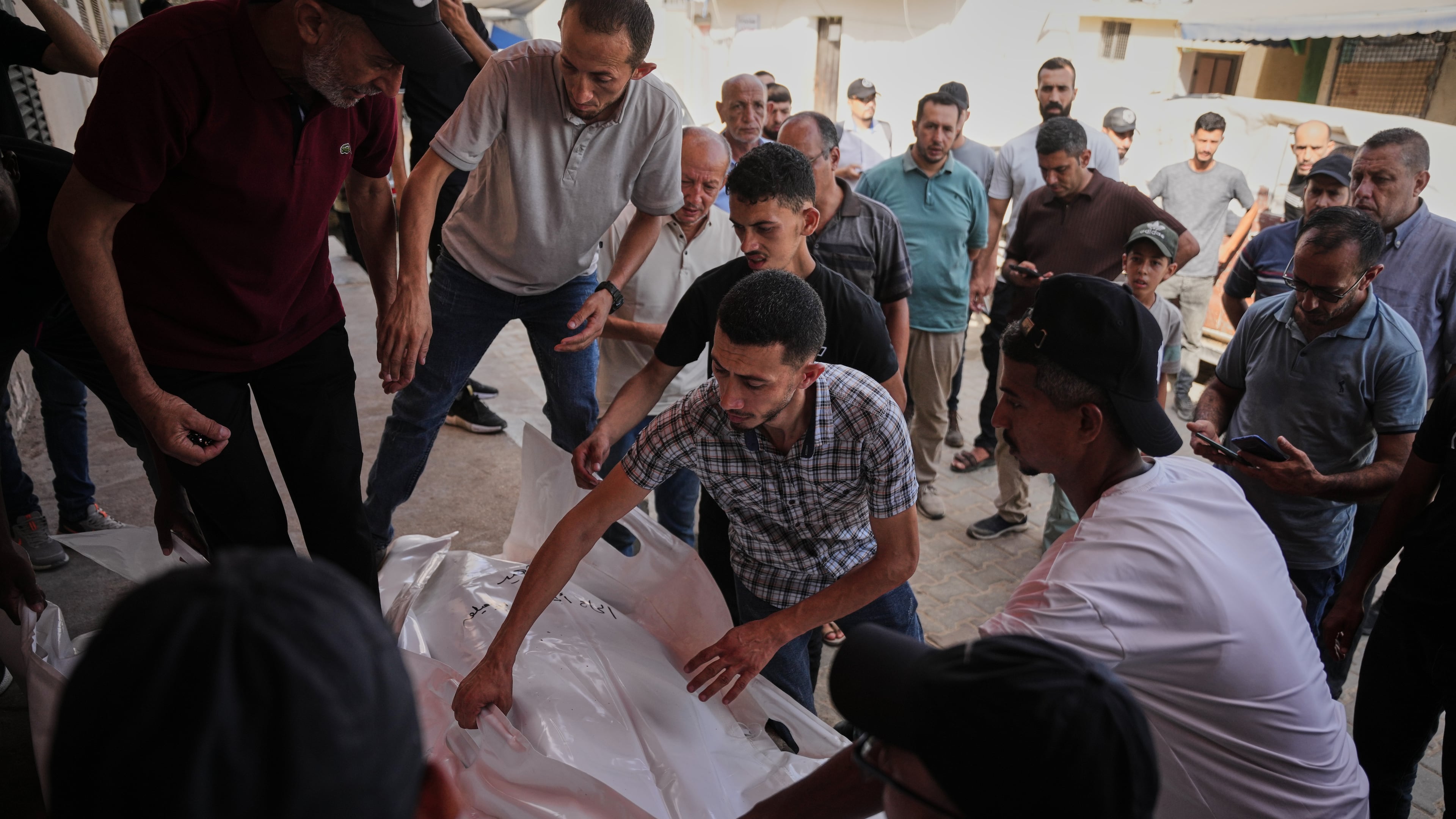 Mourners carry the bodies of Kamal Abu Muailiq, 68, and his wife, Huda Abu Muailiq, 59, who were killed in an Israeli airstrike, during their funeral in Deir al-Balah, Gaza Strip, Sunday, Aug. 2, 2026. (AP Photo/Abdel Kareem Hana)